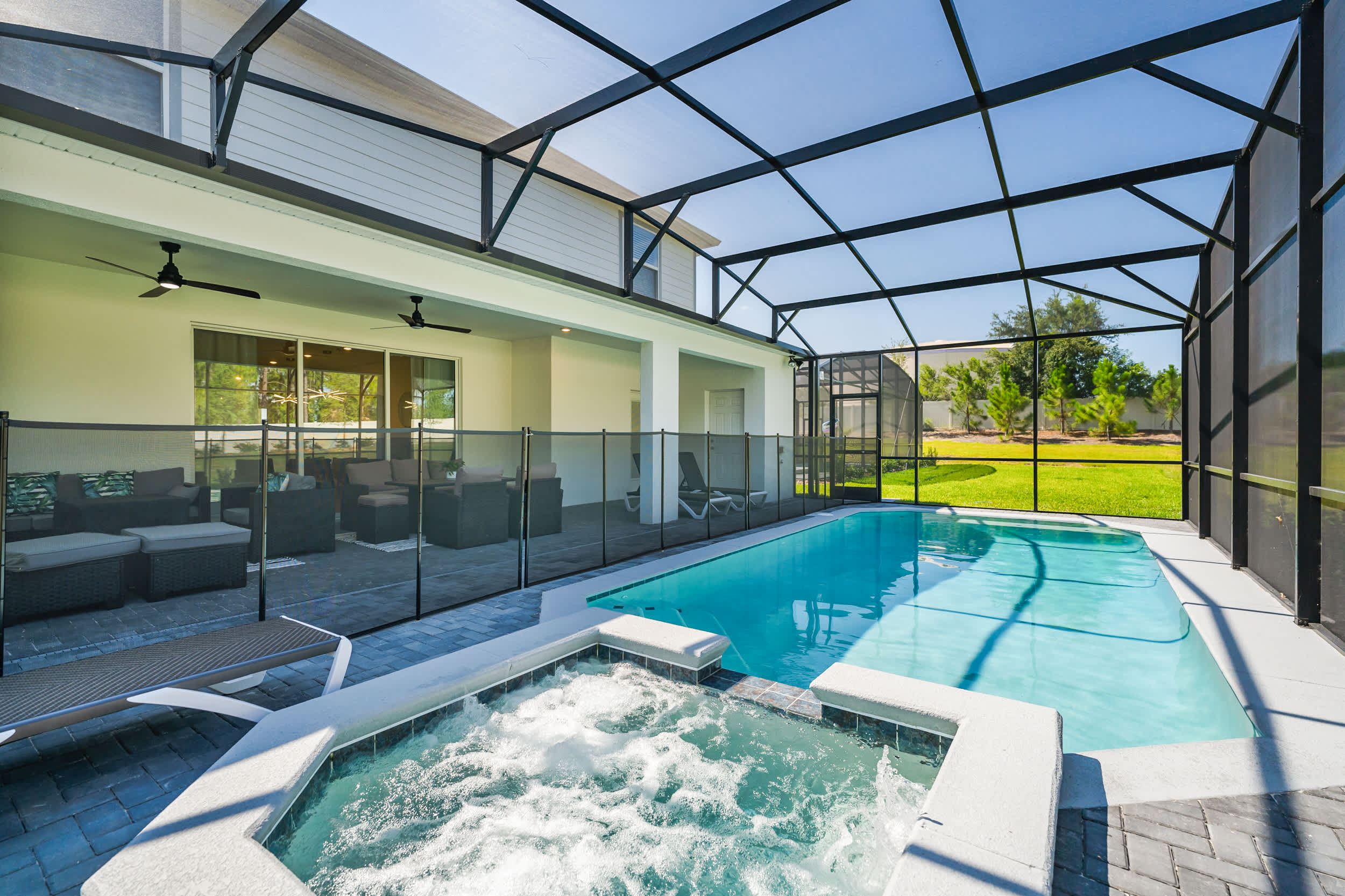 Relax in your private screened-in pool and hot tub oasis, perfect for unwinding and enjoying sunny days.
