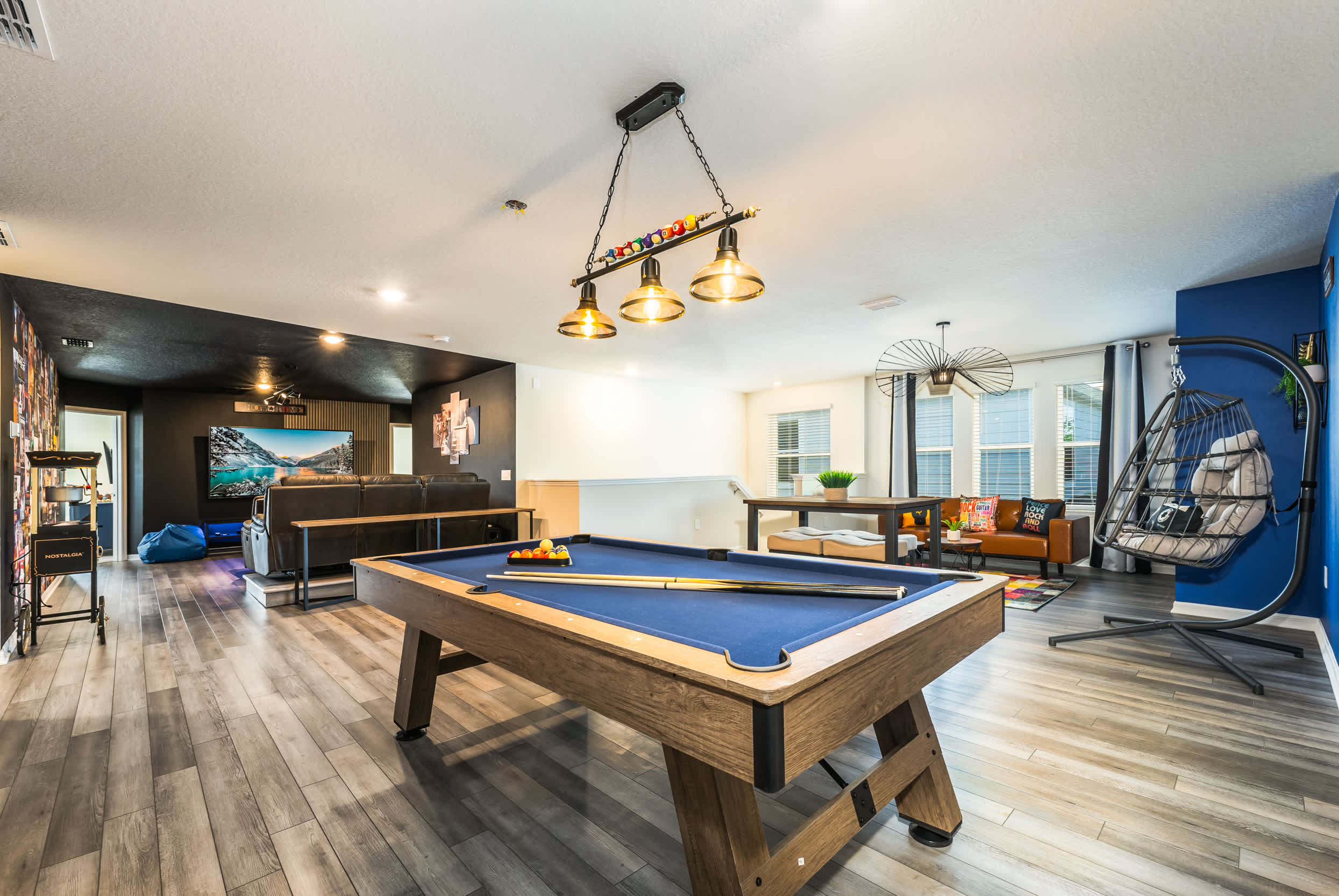 Enjoy endless fun in this stylish game room featuring a pool table, large TV, and cozy seating—perfect for group gatherings.