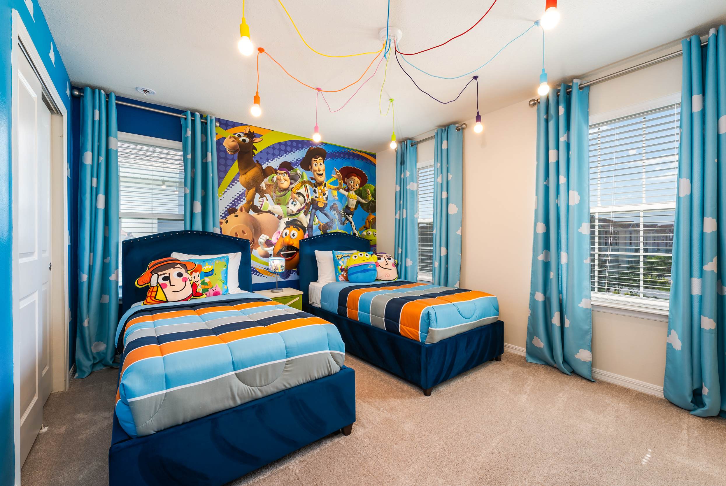 Delight your kids with this vibrant Toy Story-themed bedroom, complete with playful decor and cozy twin beds. Perfect for a memorable family stay!