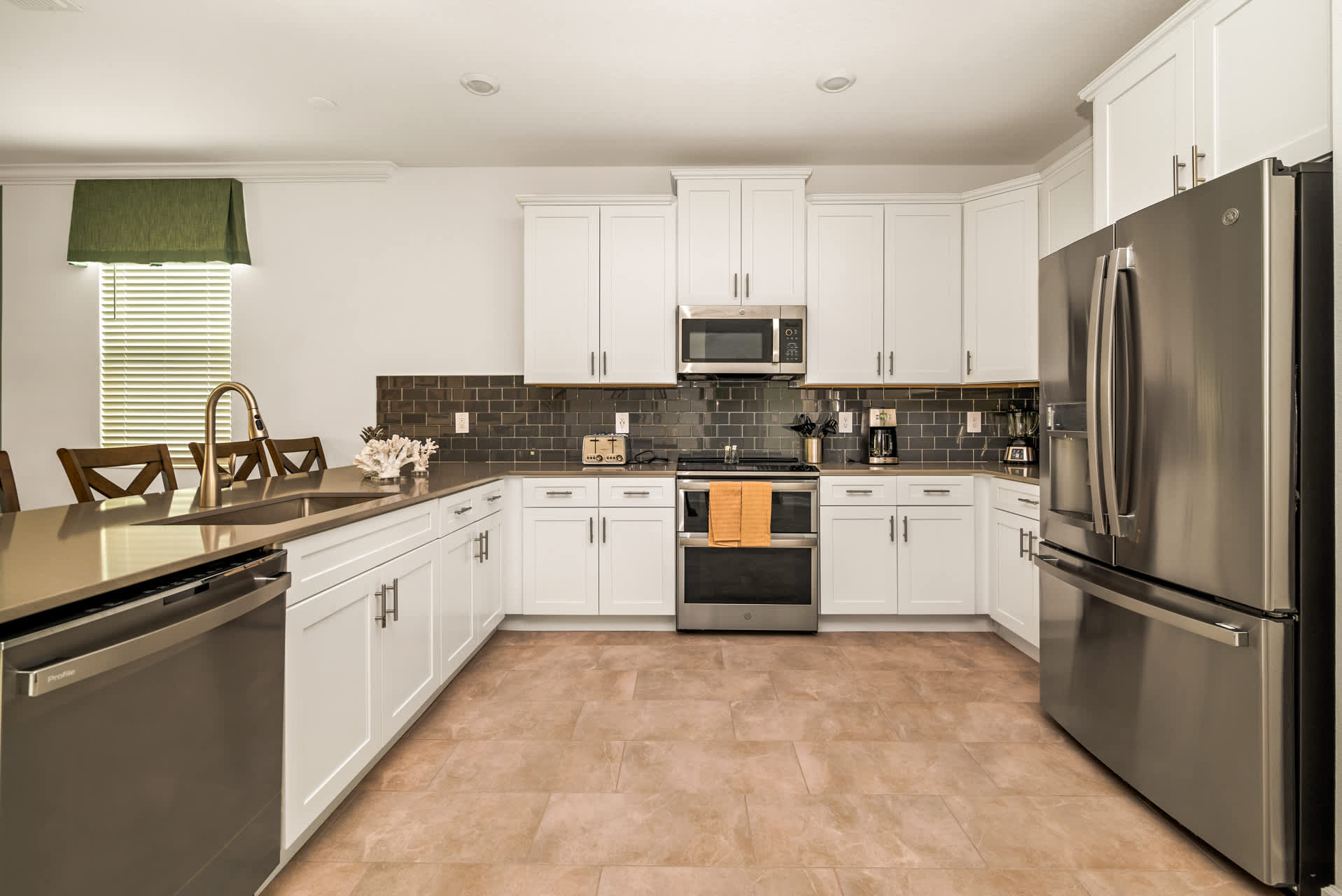 Modern kitchen with sleek appliances and ample seating, perfect for hosting family meals and gatherings.