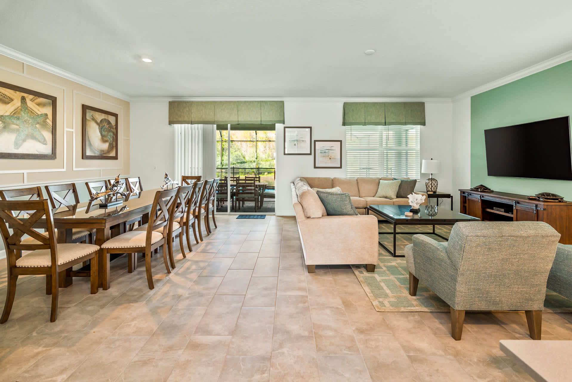 Spacious living and dining area perfect for gatherings, featuring a large sectional sofa and a stylish dining table for memorable meals.