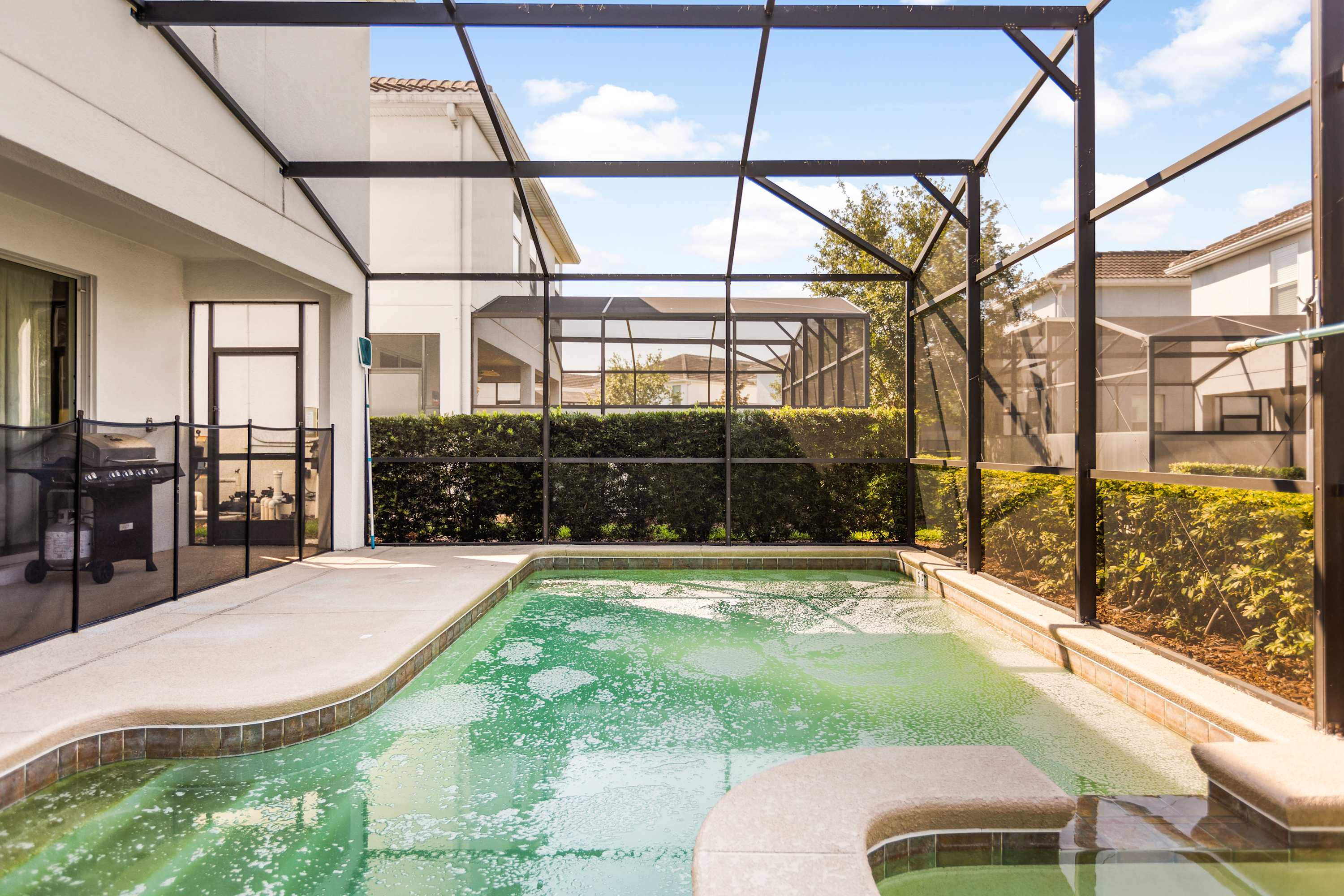 Relax in your private screened-in pool and hot tub oasis, complete with a BBQ grill for outdoor dining.