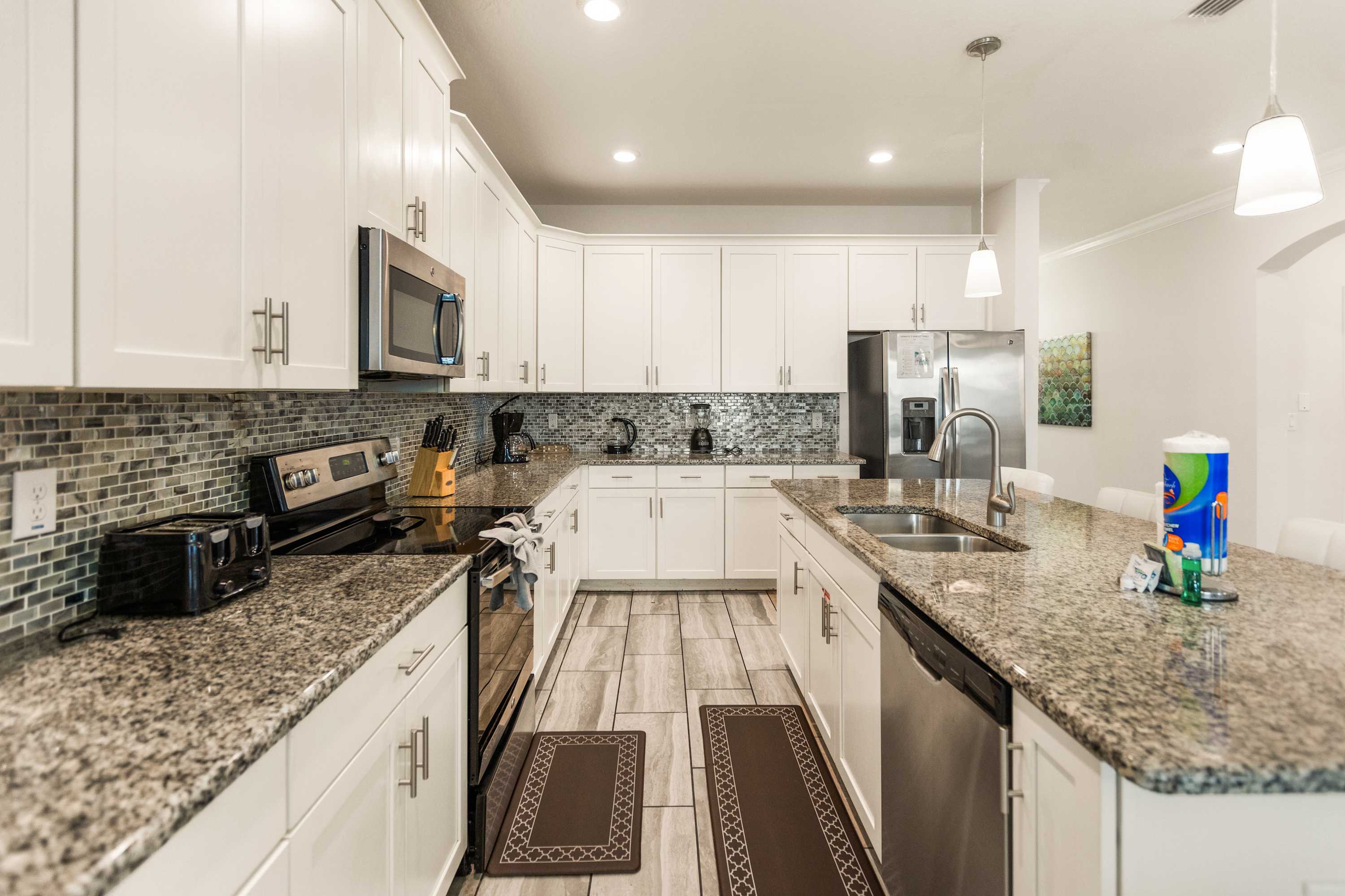 Modern kitchen with granite countertops and stainless steel appliances, perfect for cooking and entertaining.