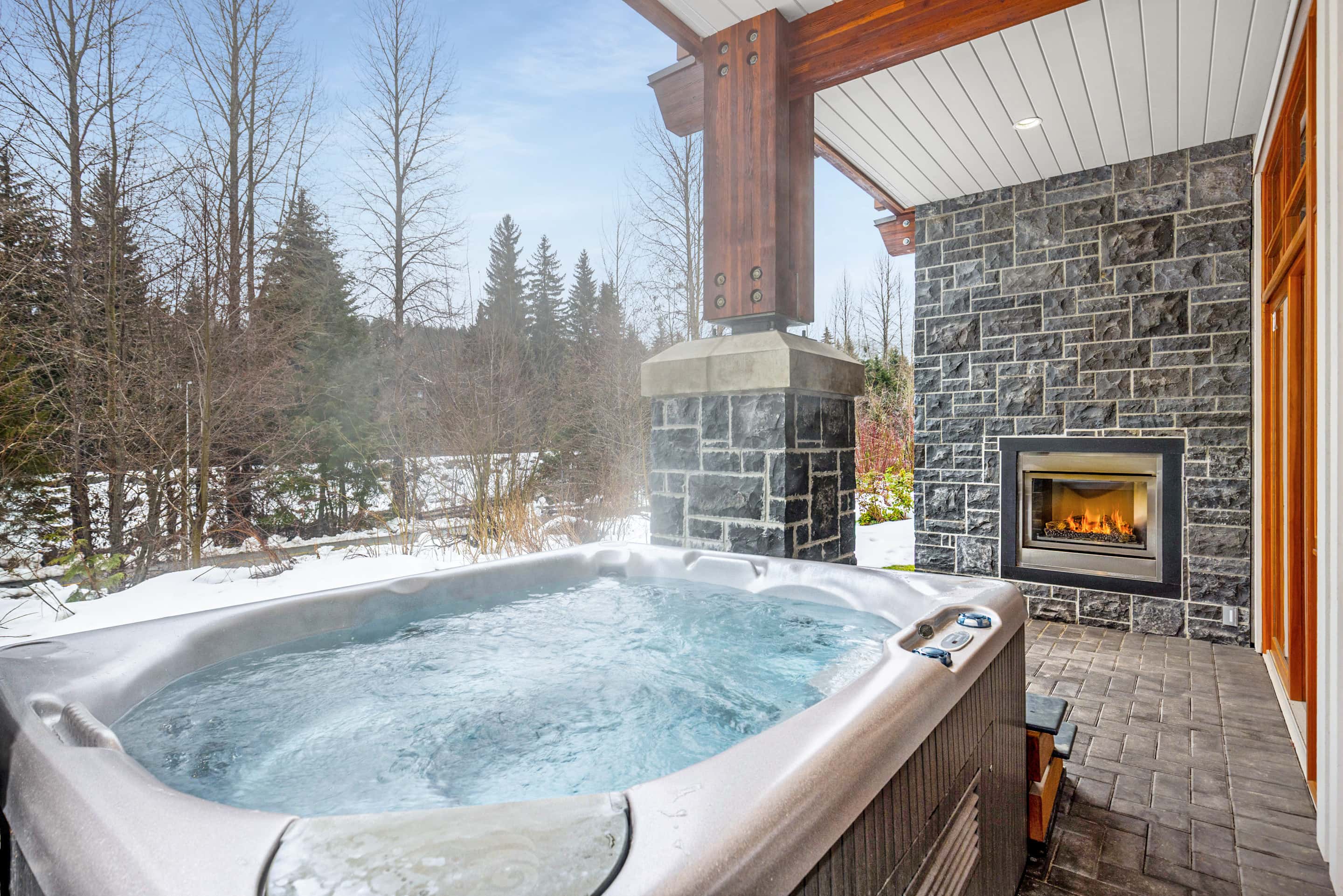 - Covered patio with a private hot tub and outdoor fireplace