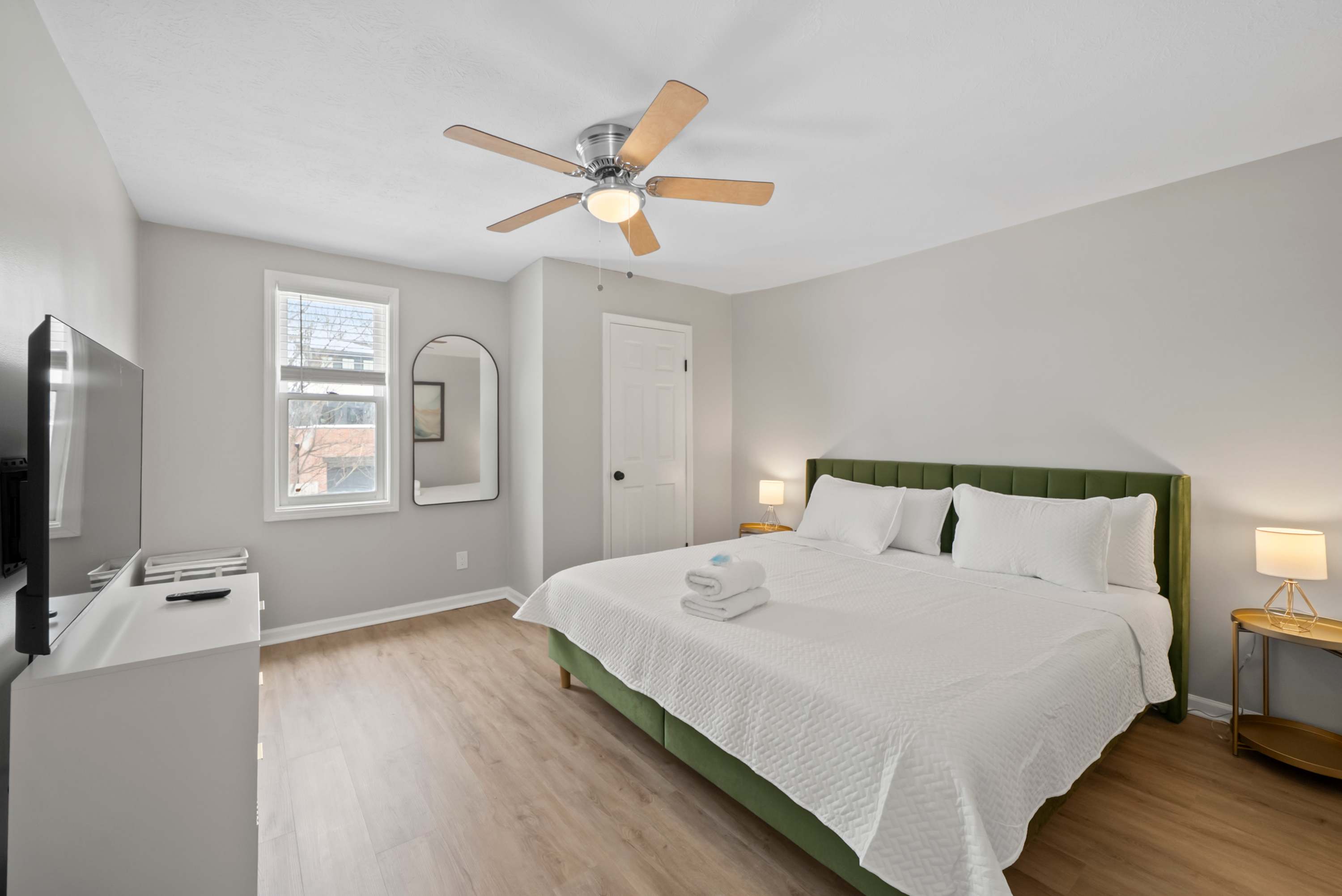 Recharge in the second bedroom, featuring a plush king bed & smart TV​
