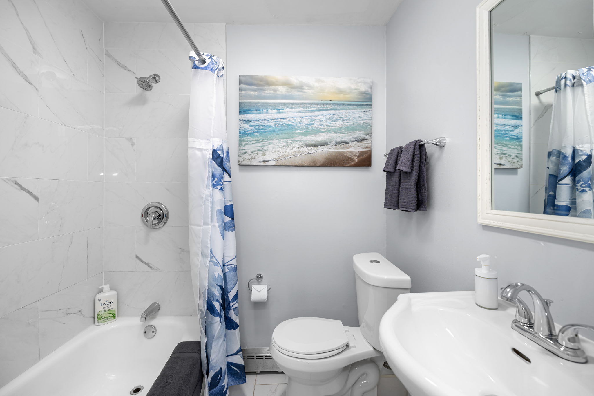 Full modern bathroom with shower and bathtub combo