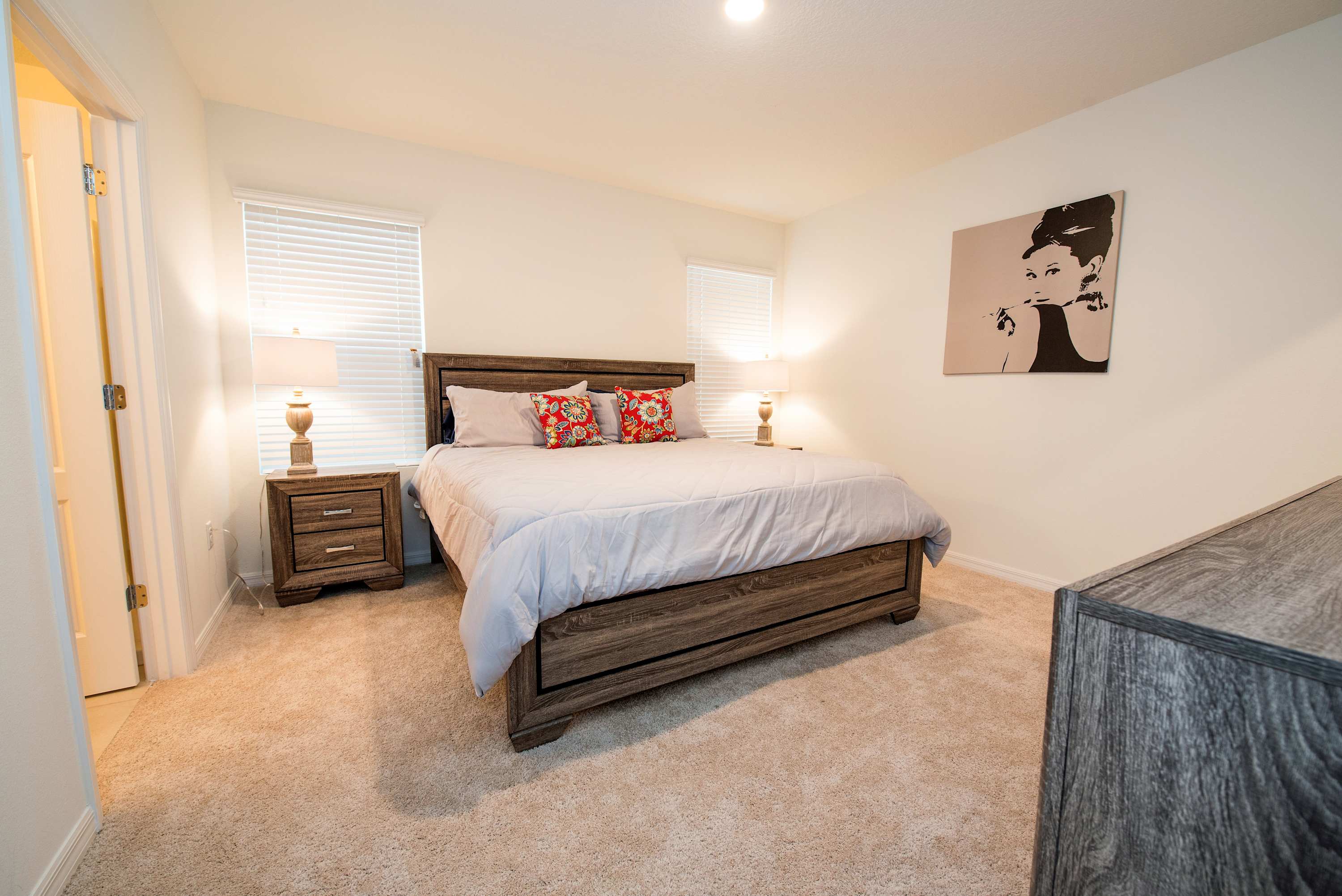 Relax in this cozy bedroom with plush bedding and stylish decor, perfect for unwinding after a day of exploring.
