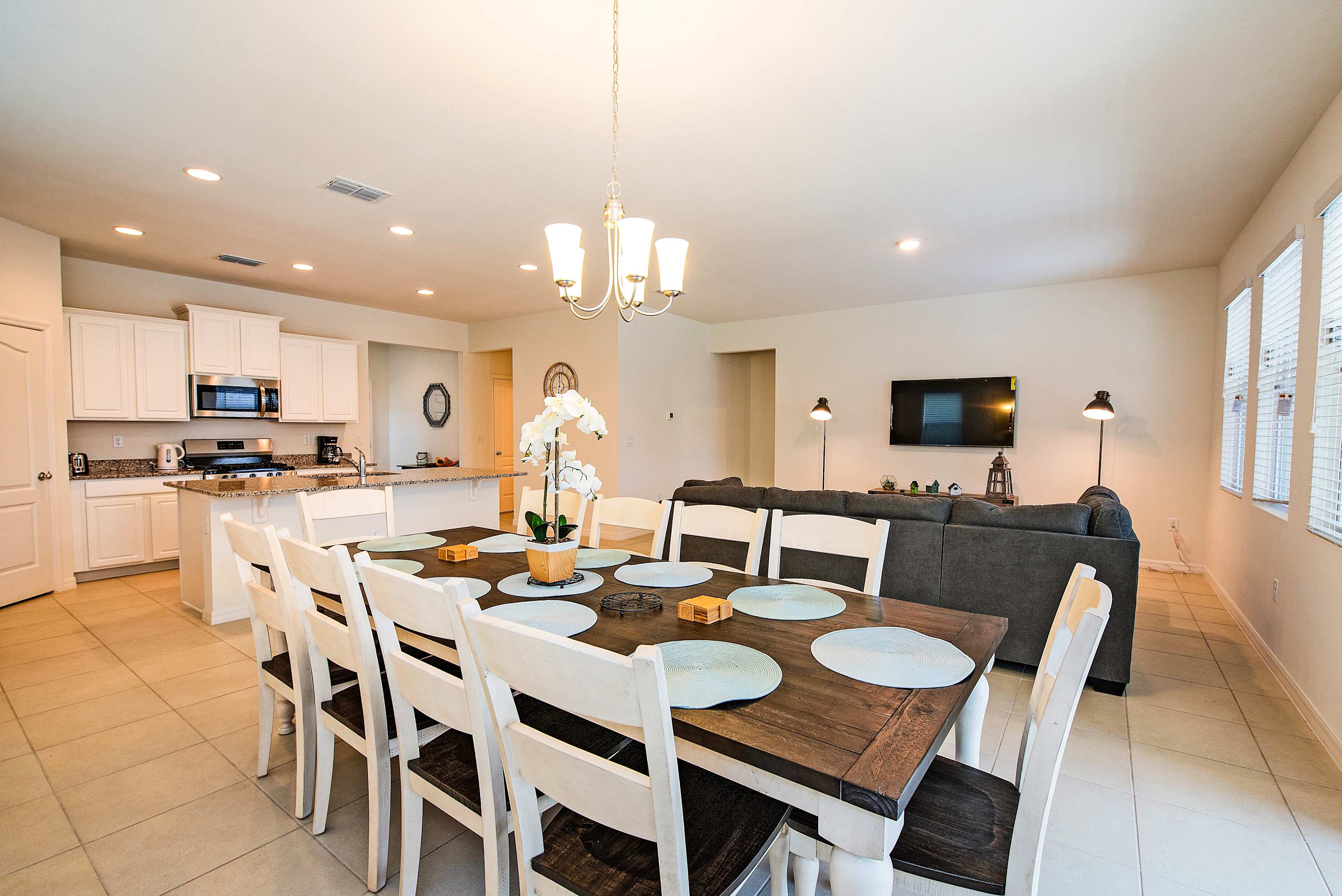 Spacious dining area perfect for family gatherings, featuring a large table and modern kitchen amenities.