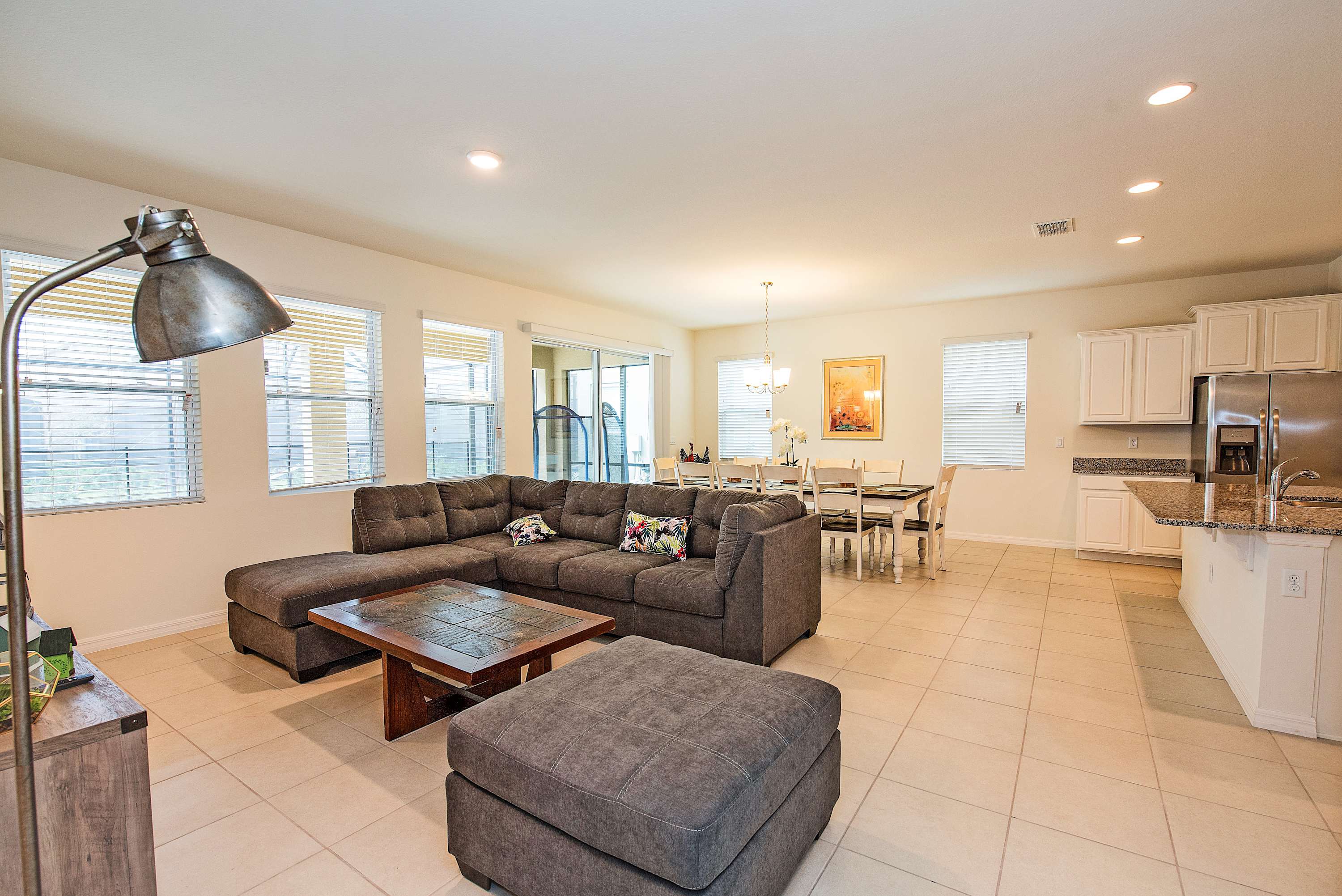 Spacious open-plan living and dining area with modern amenities and ample natural light, perfect for family gatherings.