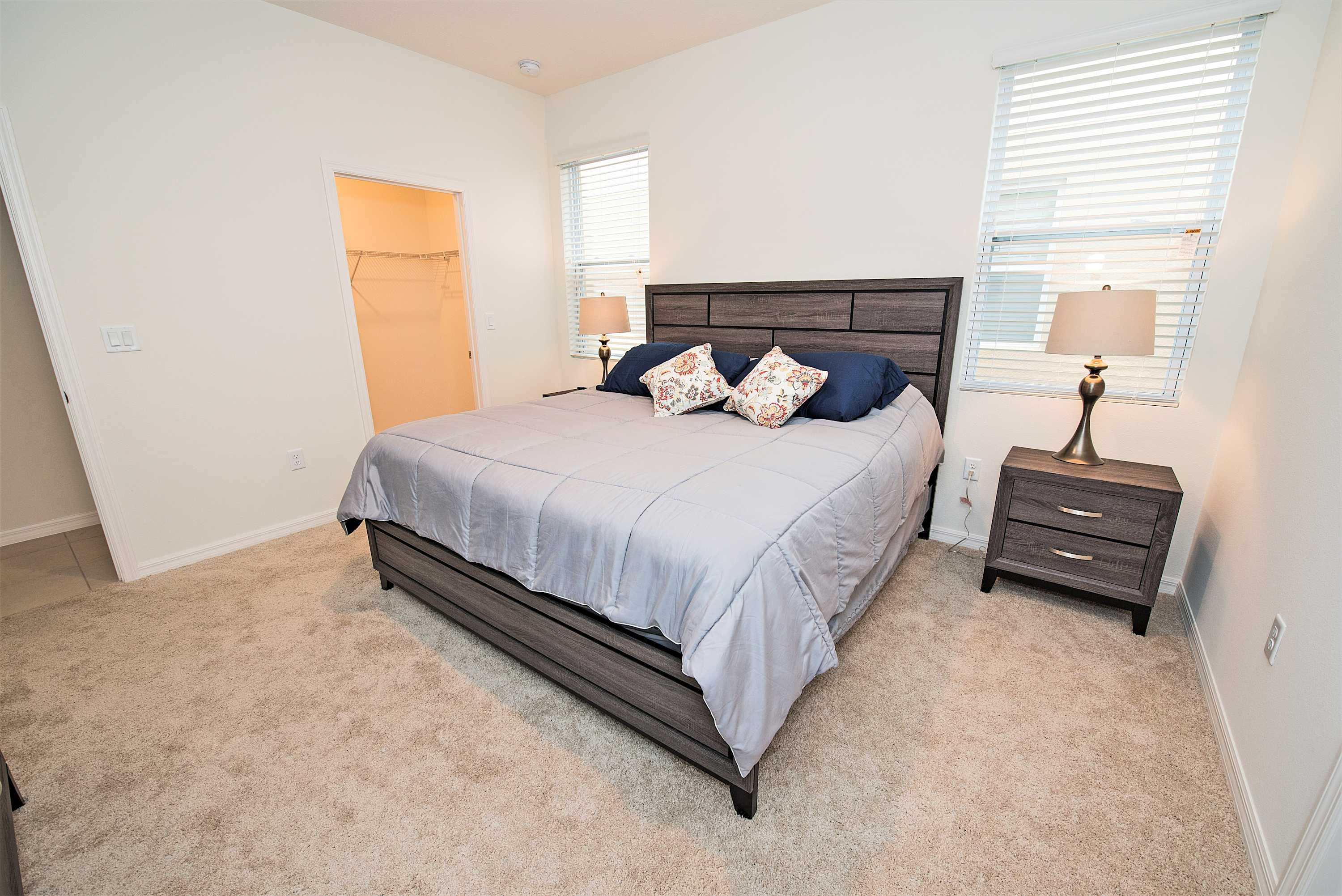 Relax in this spacious bedroom with a plush king-sized bed and ample natural light.