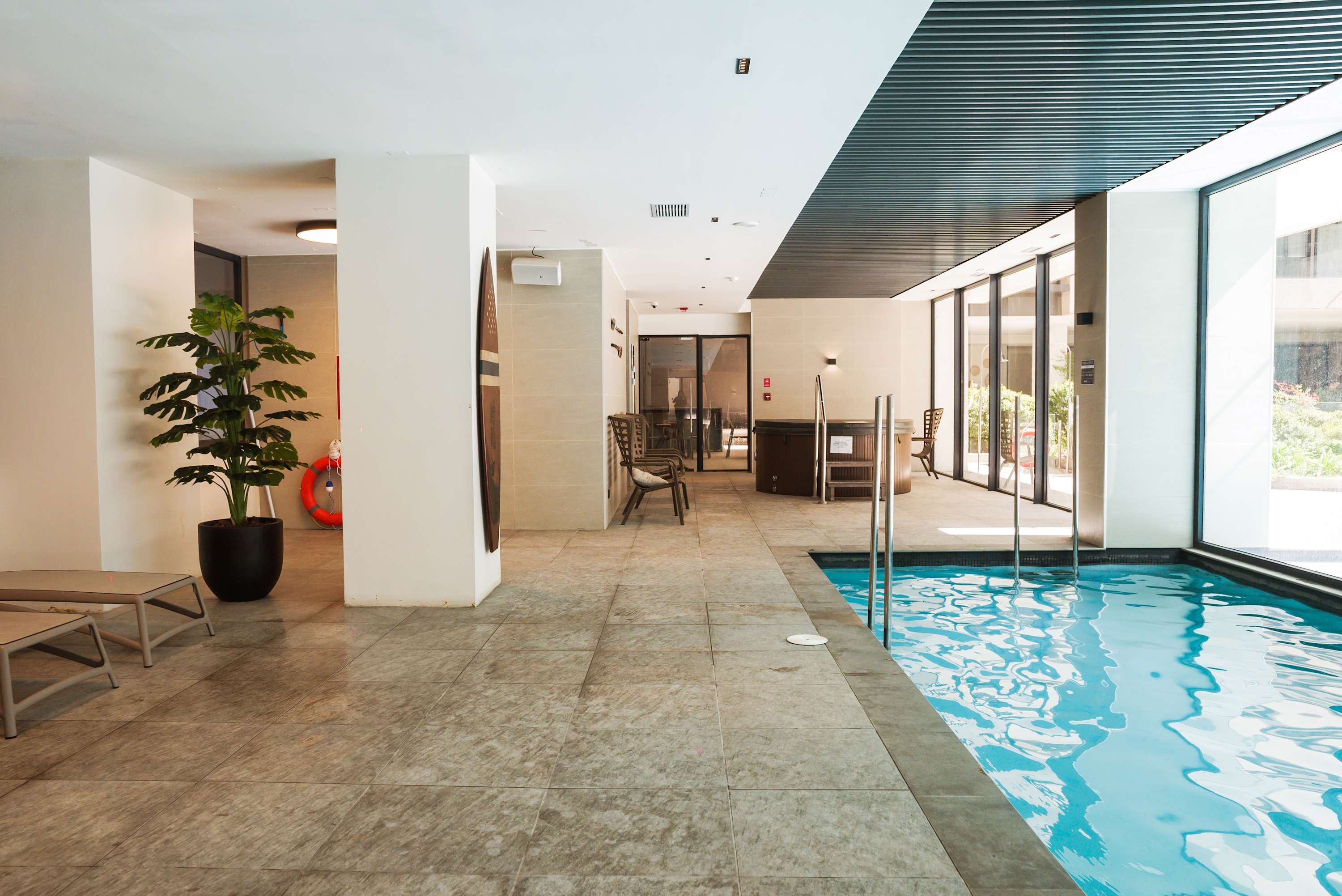 Relax by the indoor pool and enjoy the natural light streaming through large windows.