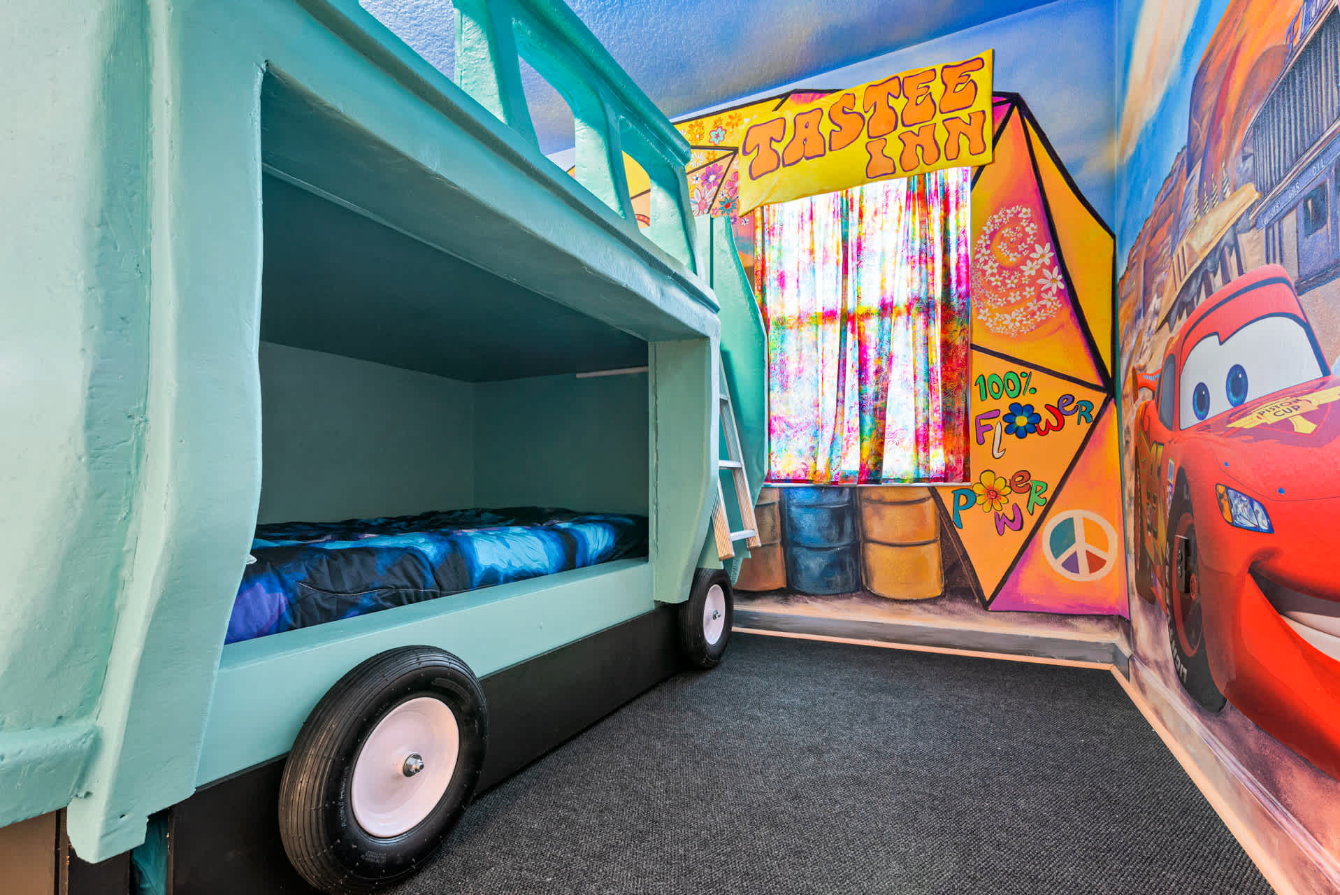 Ignite your child's imagination in this car-themed room with a custom bunk bed and vibrant murals, perfect for young adventurers.