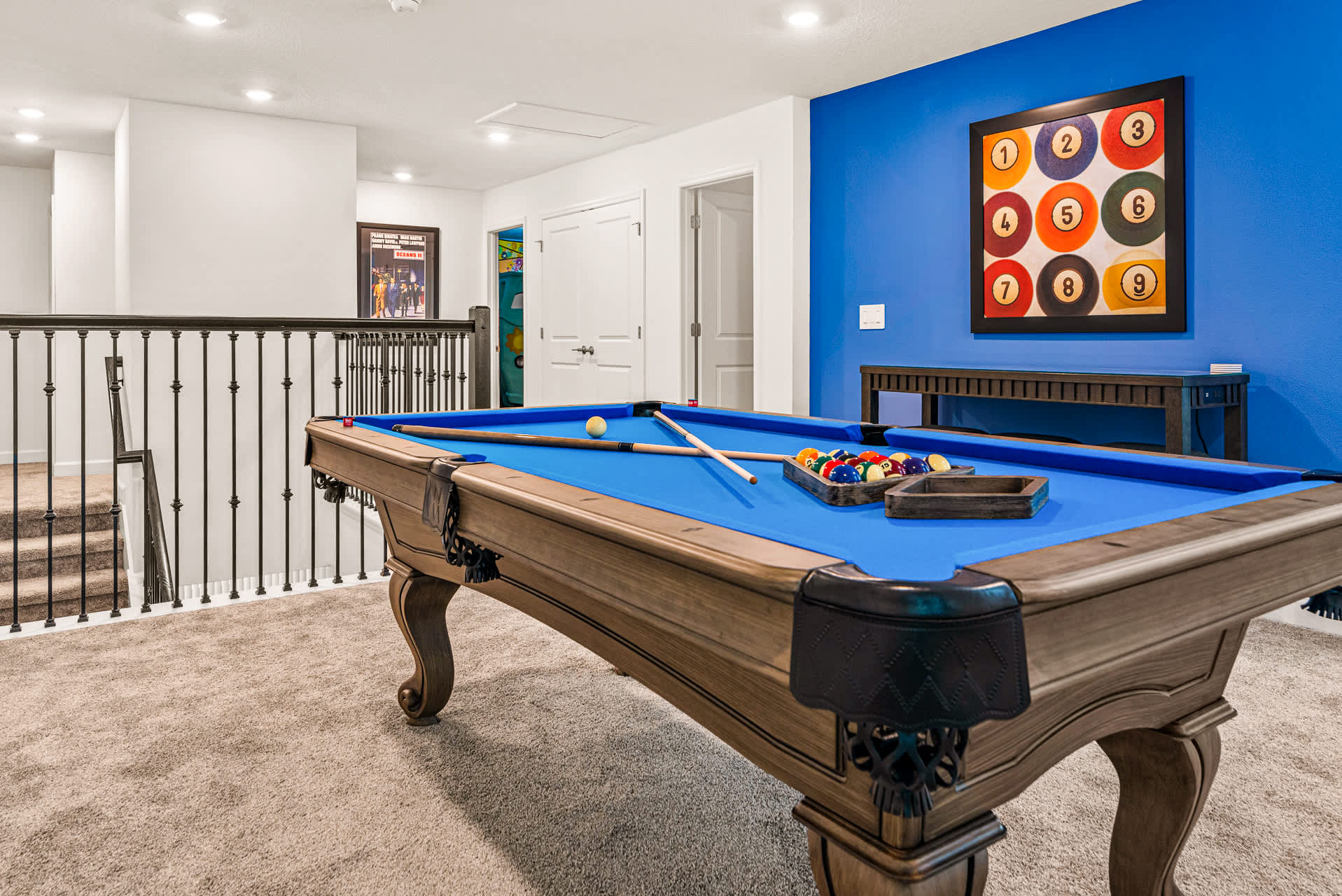 Enjoy a game of pool in this vibrant and stylish game room, perfect for friendly competitions and relaxation.