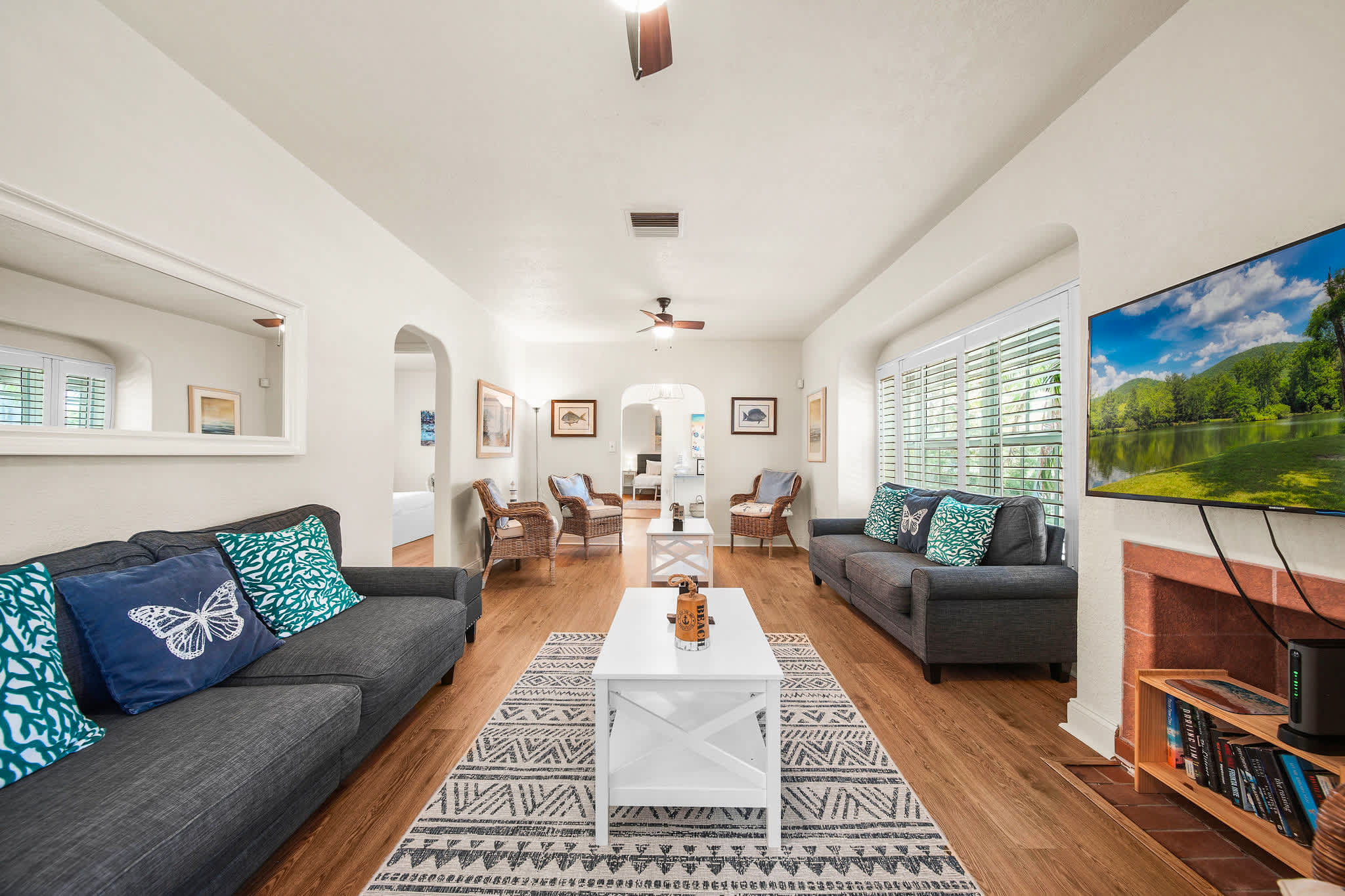 Relax in this bright and inviting living room with cozy seating and a large TV, perfect for unwinding after a day of exploring.