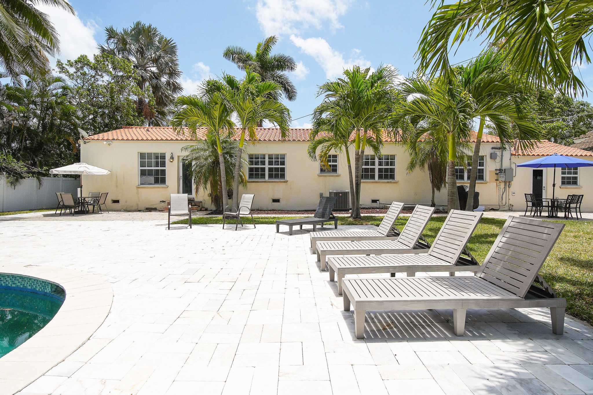 Relax in this sunny outdoor oasis with a pool and ample seating, perfect for enjoying the Florida sunshine.