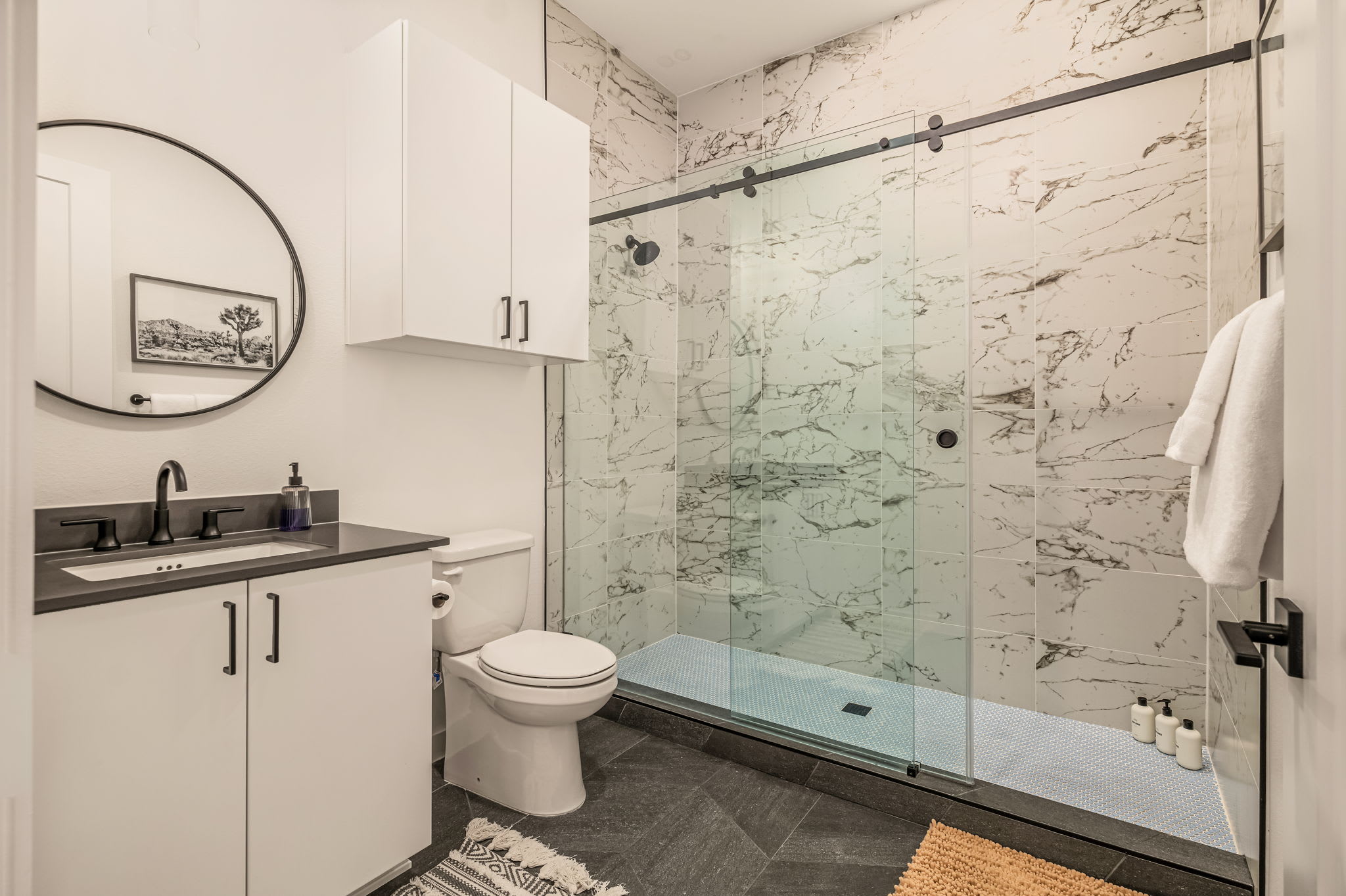 Bathroom with walk-in shower and marble tile