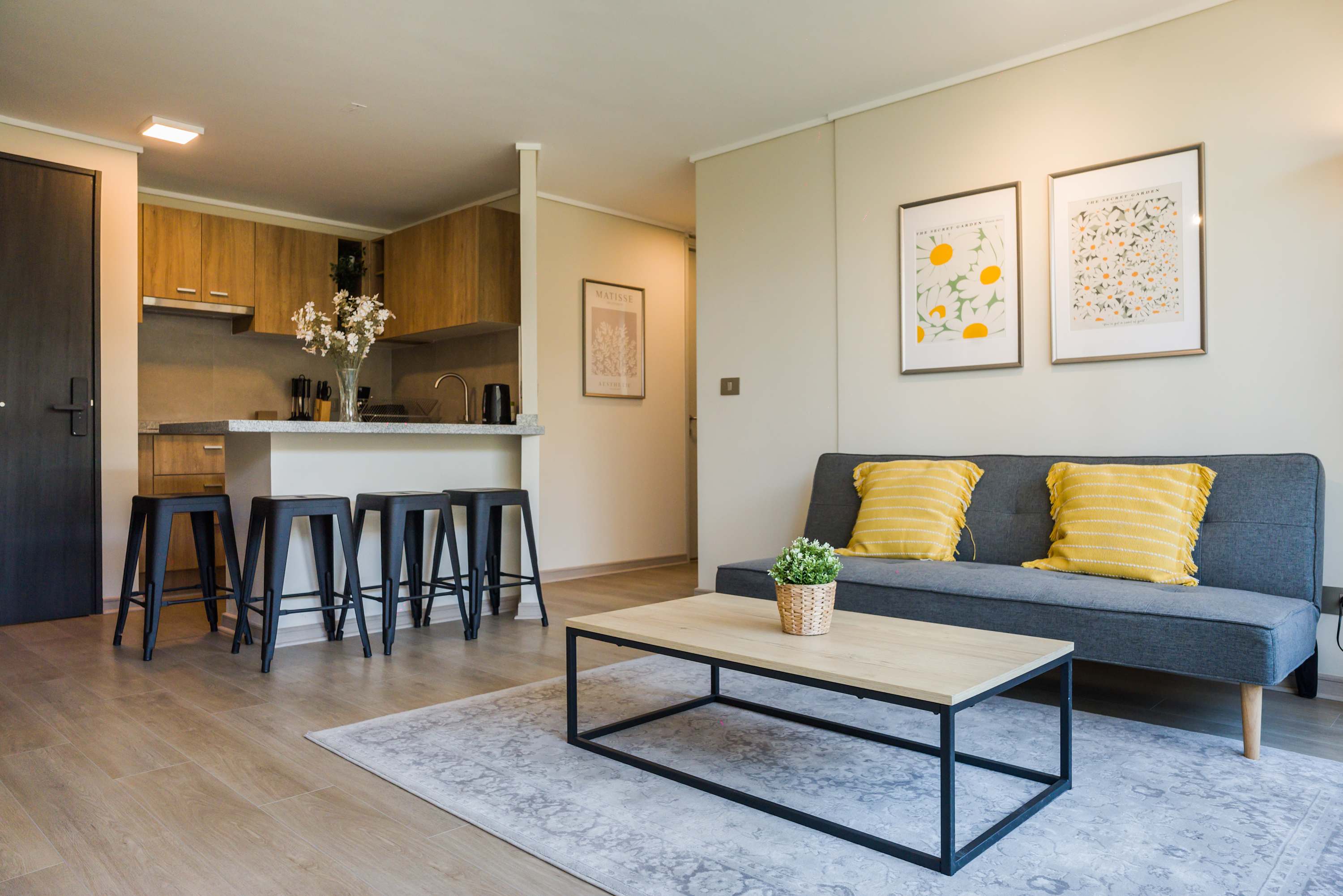 Cozy and stylish living area with a modern kitchen, perfect for relaxing or entertaining guests.