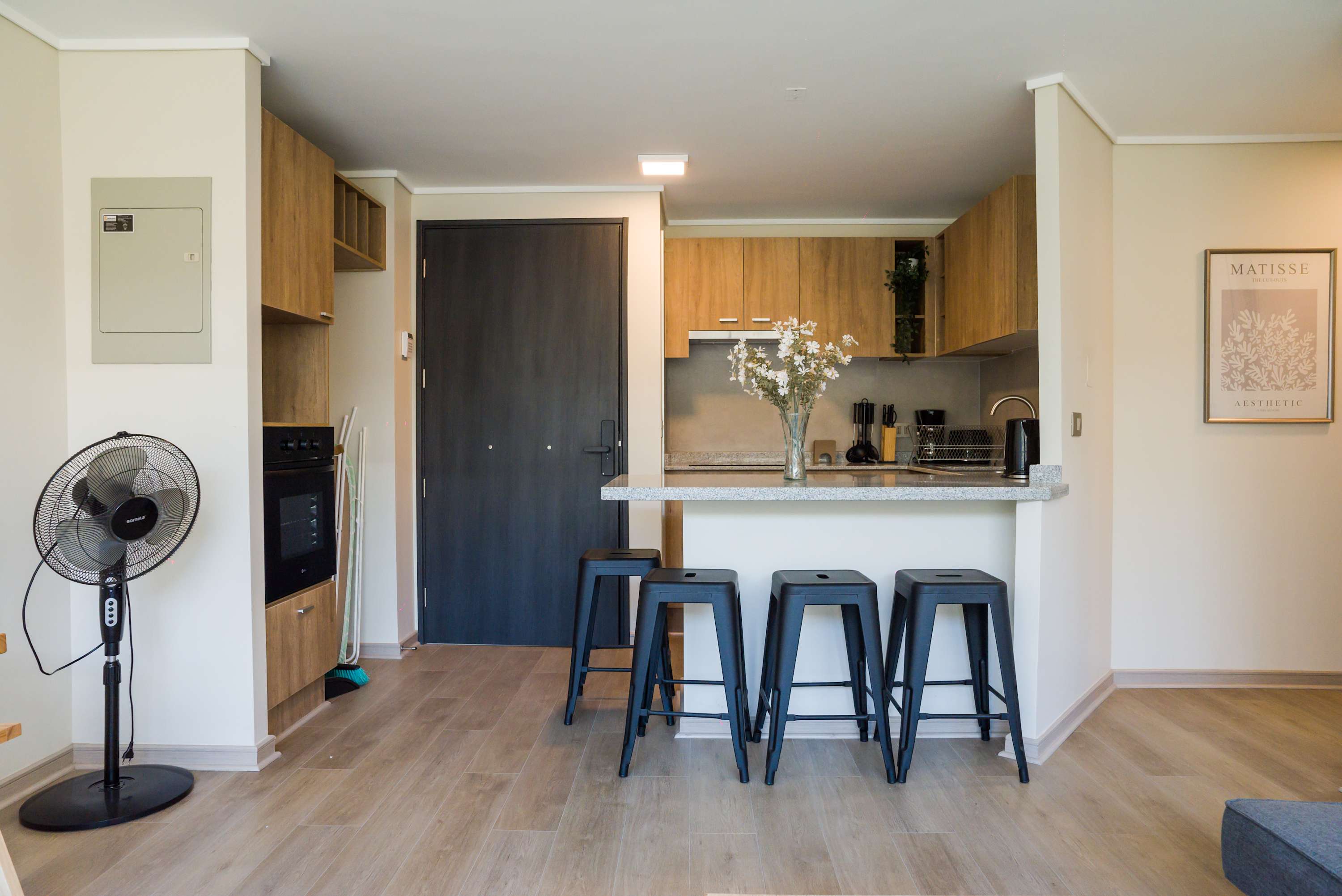 Stylish kitchen with modern amenities and cozy seating for four, perfect for enjoying meals and gatherings.