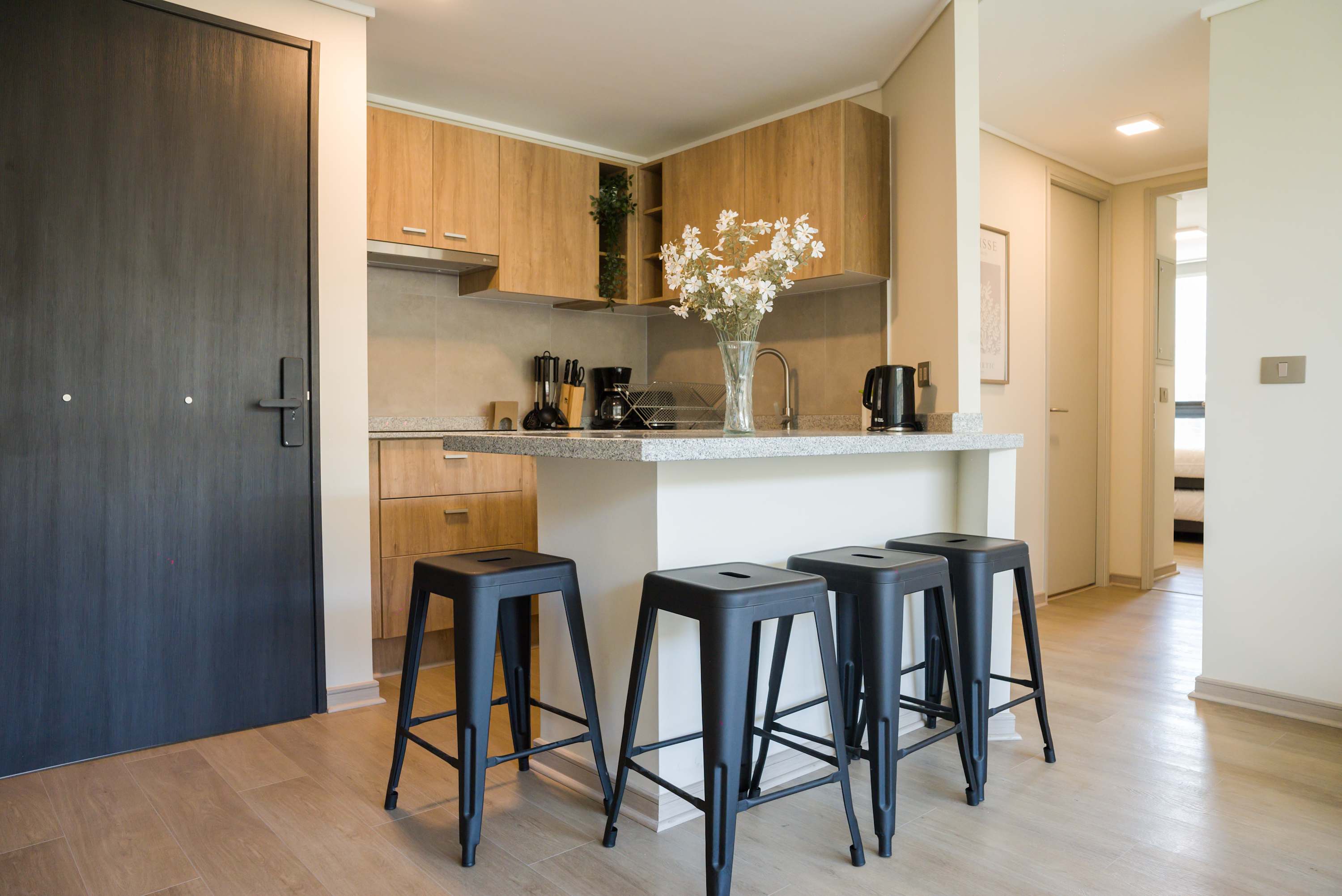 Stylish kitchen with modern amenities and seating for four, perfect for cooking and socializing.