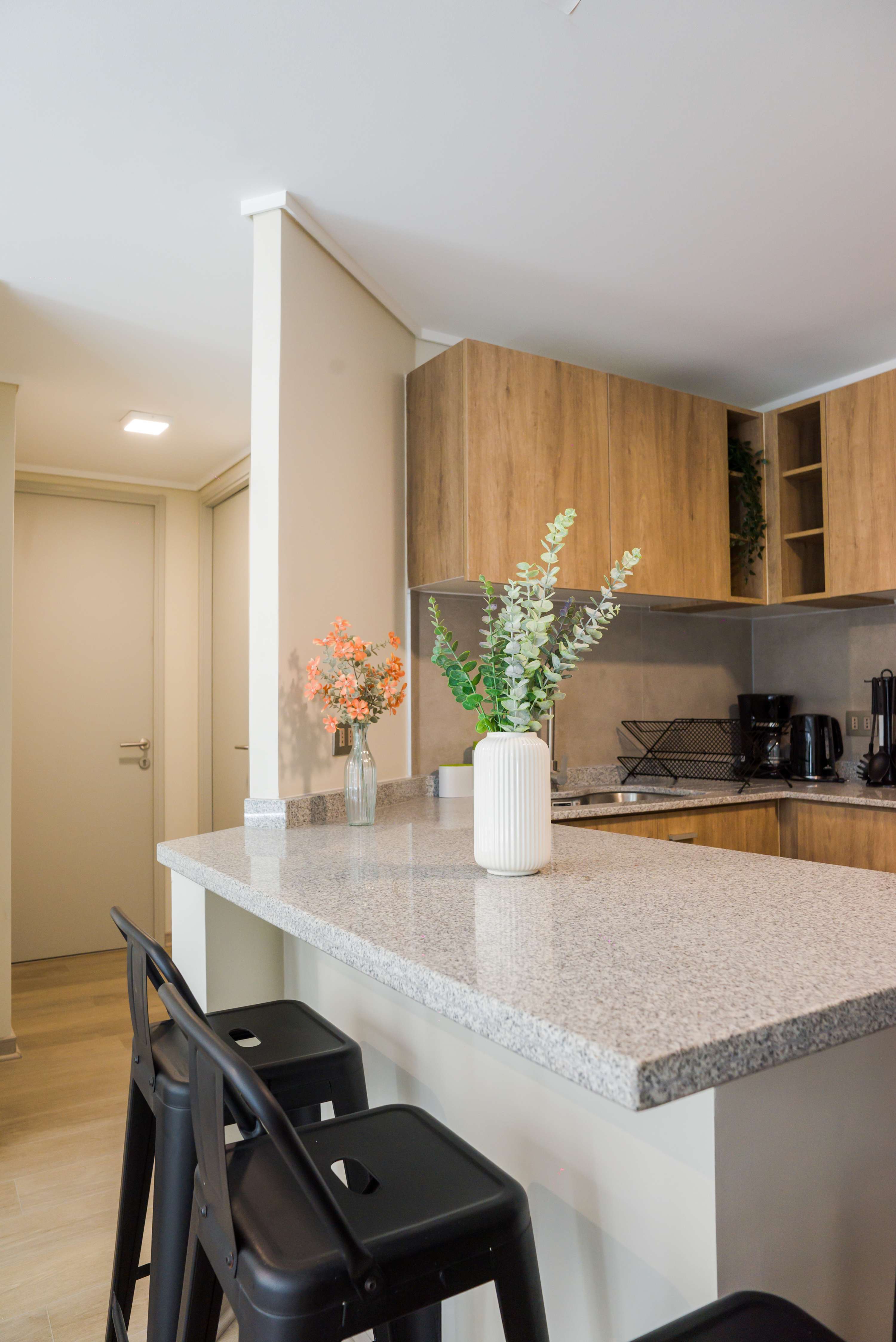 Sleek and modern kitchen with stylish bar seating, perfect for casual dining and entertaining.