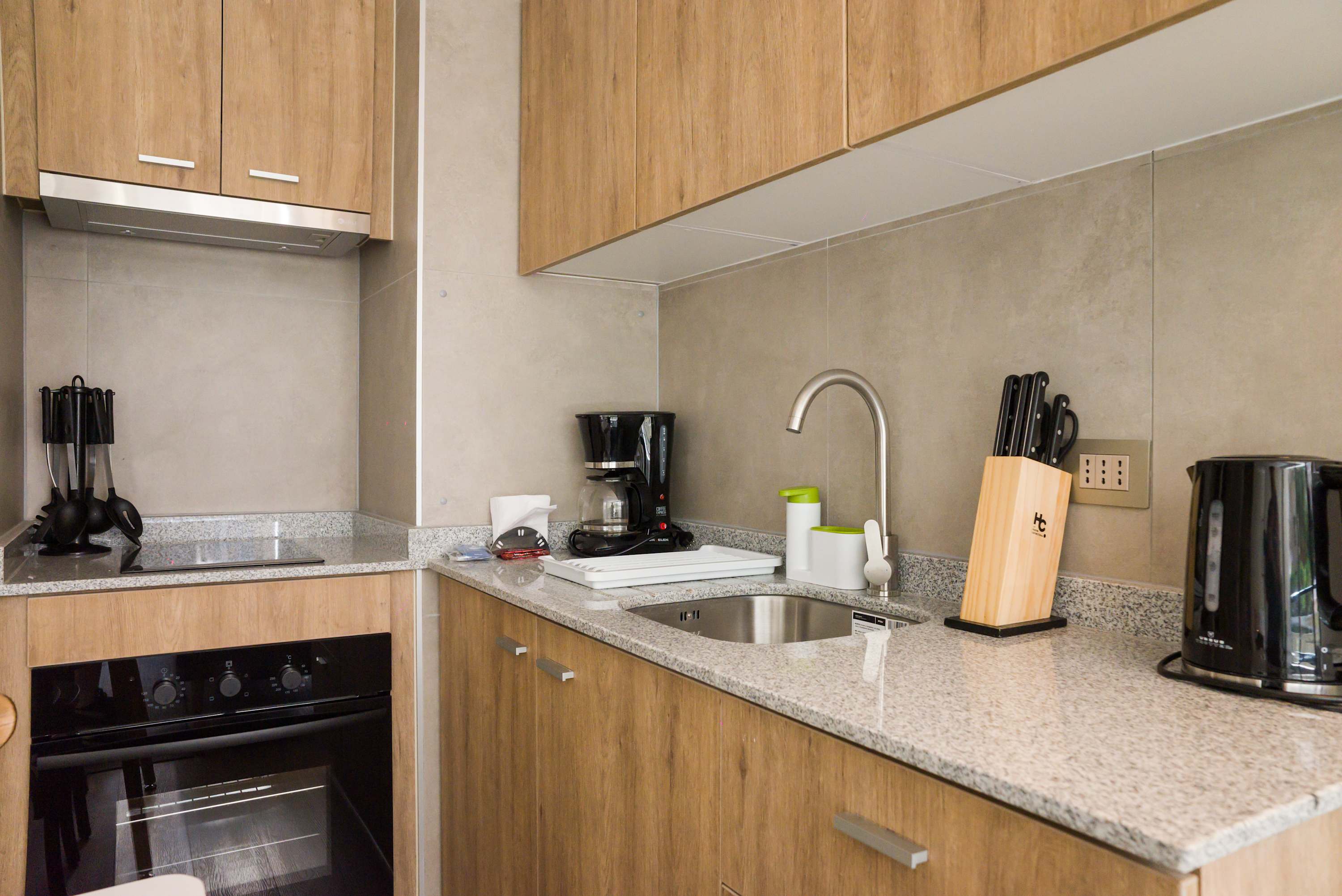 Modern kitchen with essential appliances and sleek design, perfect for preparing meals during your stay.