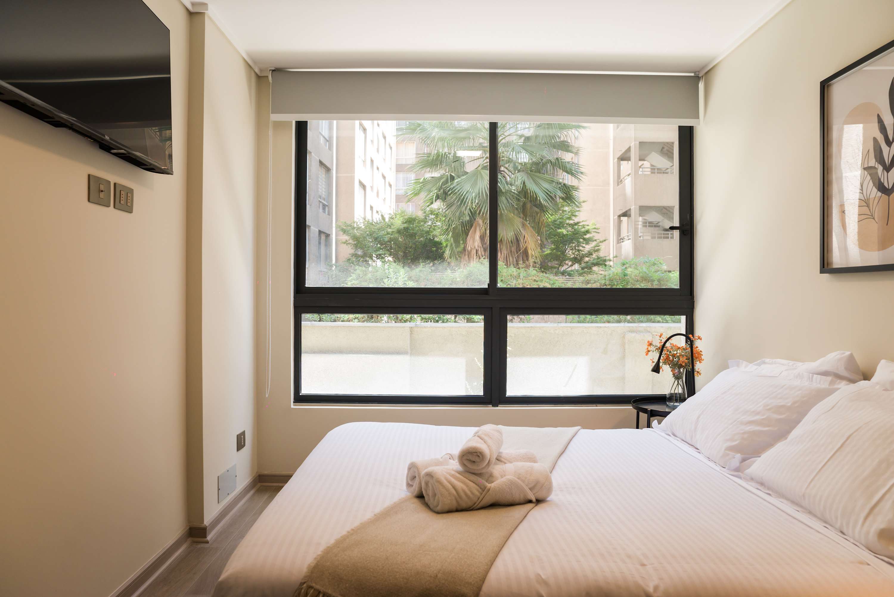 Bright and cozy bedroom with a view, perfect for relaxation in the heart of the city.