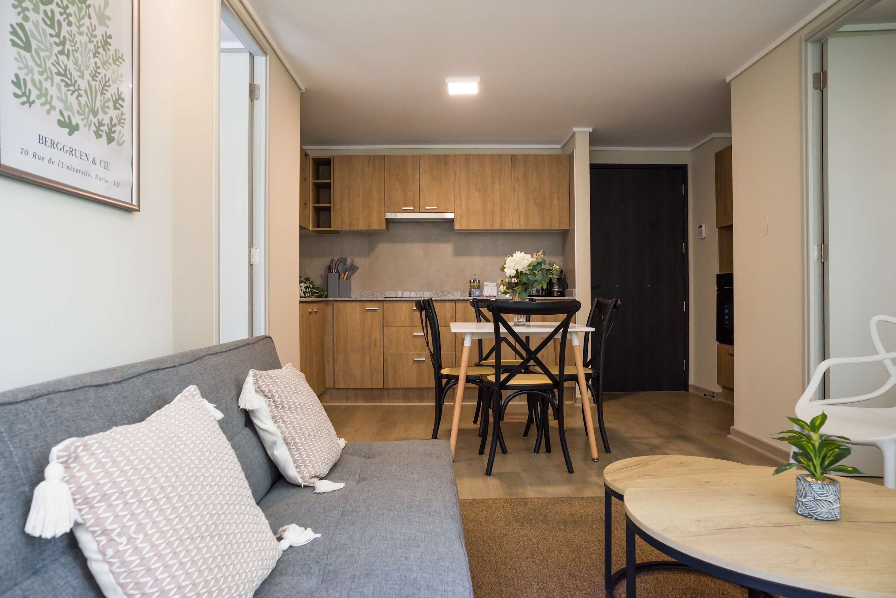 Charming living area with cozy seating and a functional kitchen, perfect for relaxing and dining.