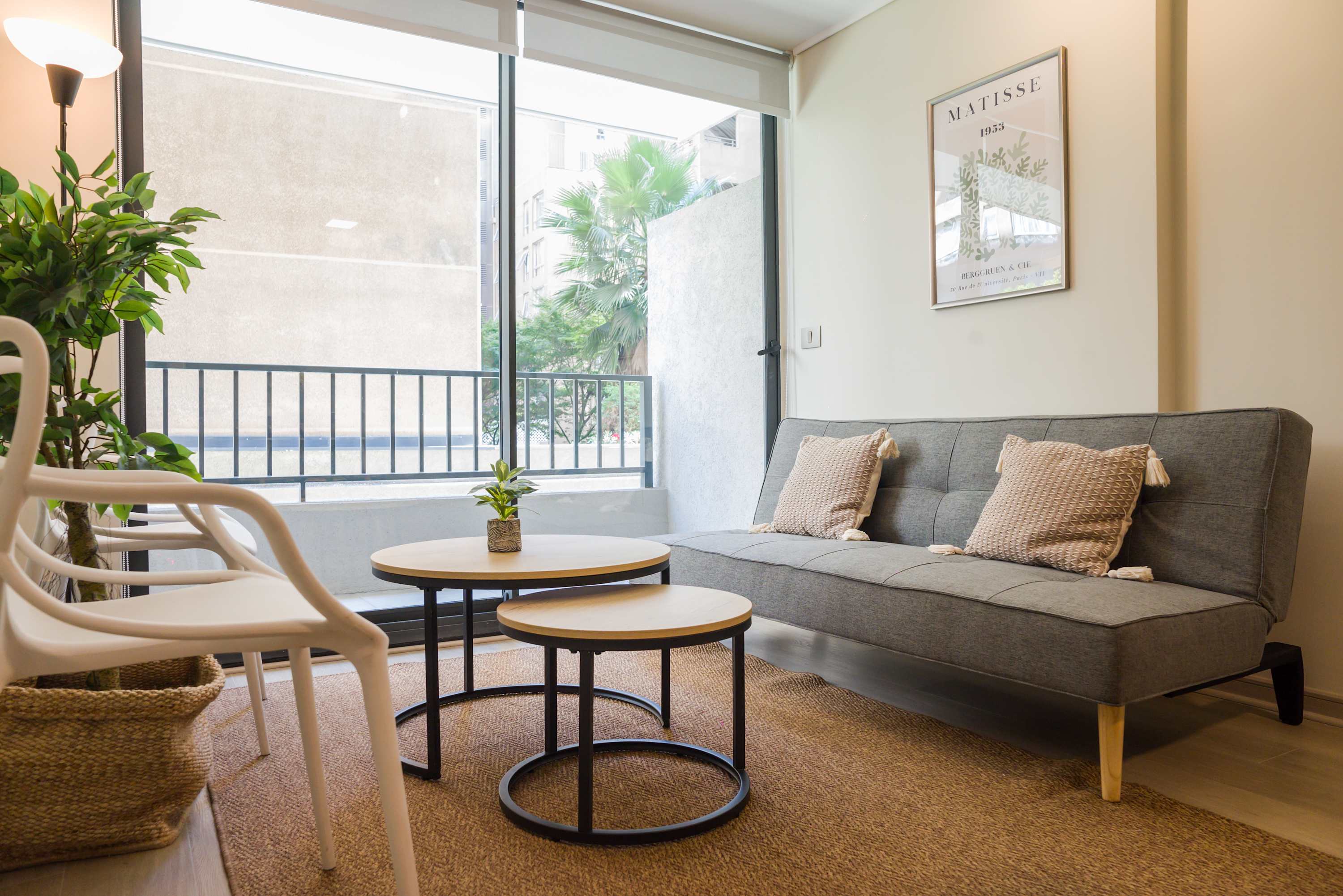 Cozy living room with natural light and modern decor, perfect for relaxing after a day exploring the city.