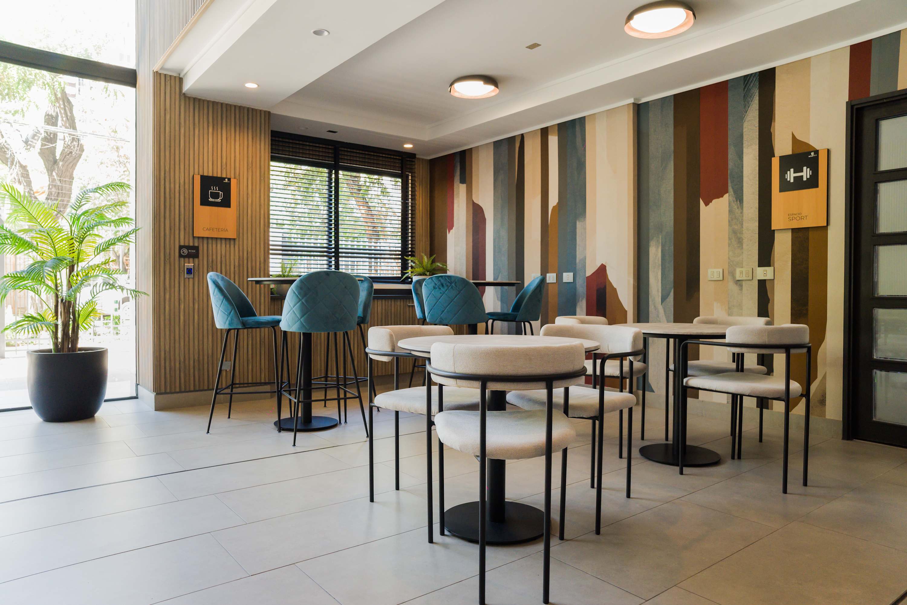 Relax in this stylish lounge with vibrant decor and ample seating, perfect for unwinding or socializing.