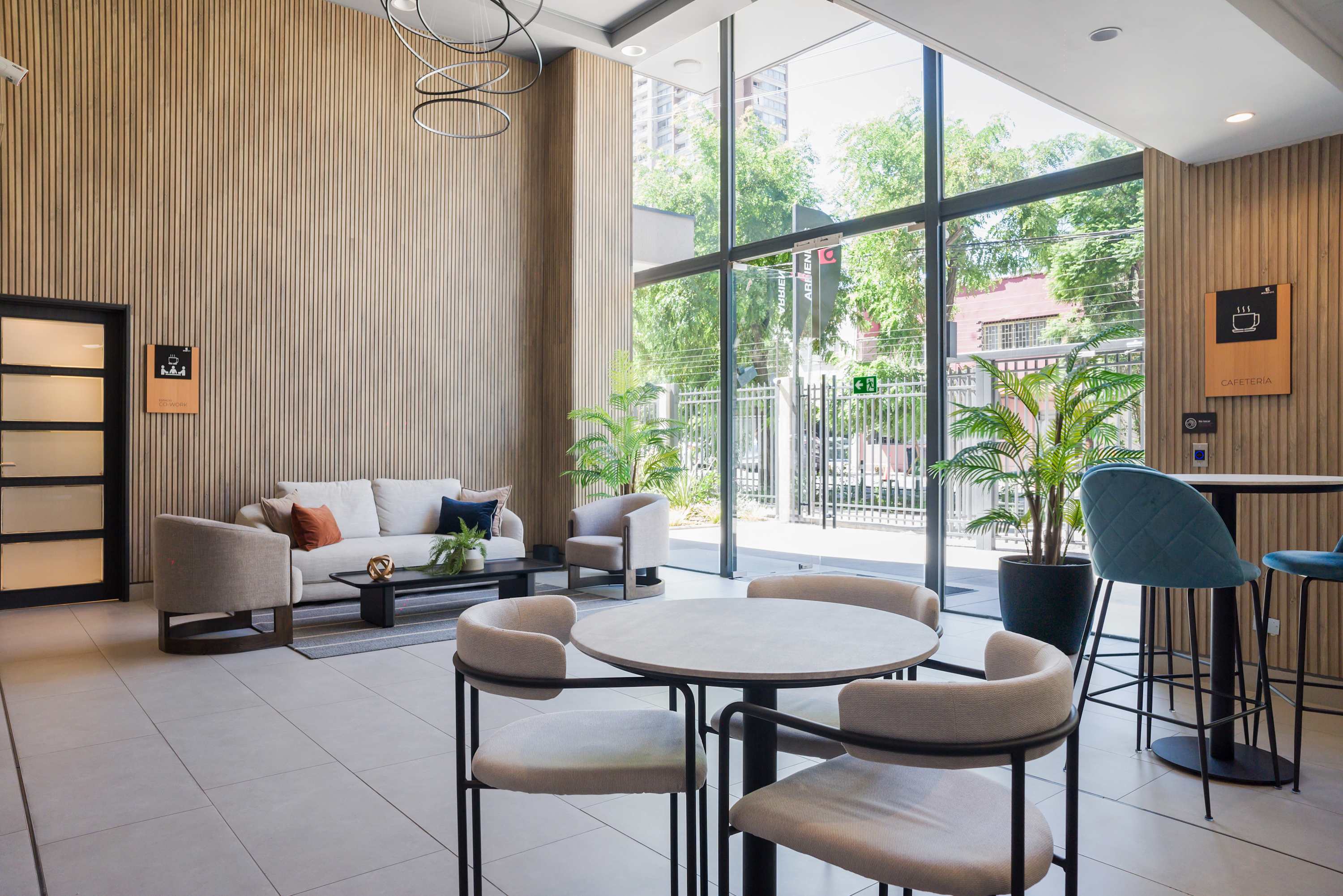 Relax in this stylish lounge with ample natural light and modern decor, perfect for unwinding or socializing.