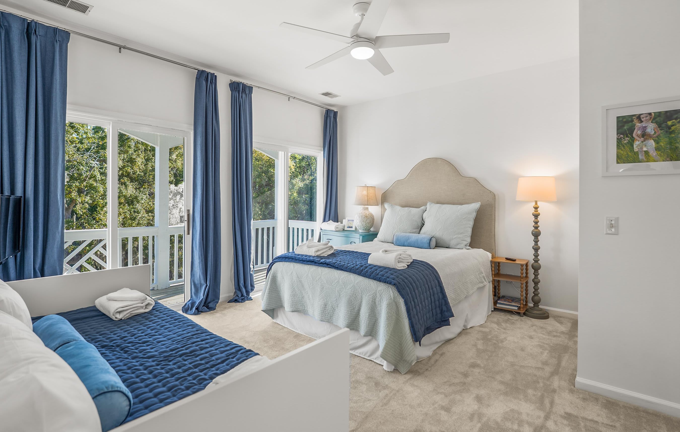 Queen Bed with a Twin Bed with Twin Trundle, Comfortably Sleeping Additional Guests. It Includes an Ensuite Bath (shower/tub combo) and Access to a Shared Deck with Seating Overlooking Bonito Road. 