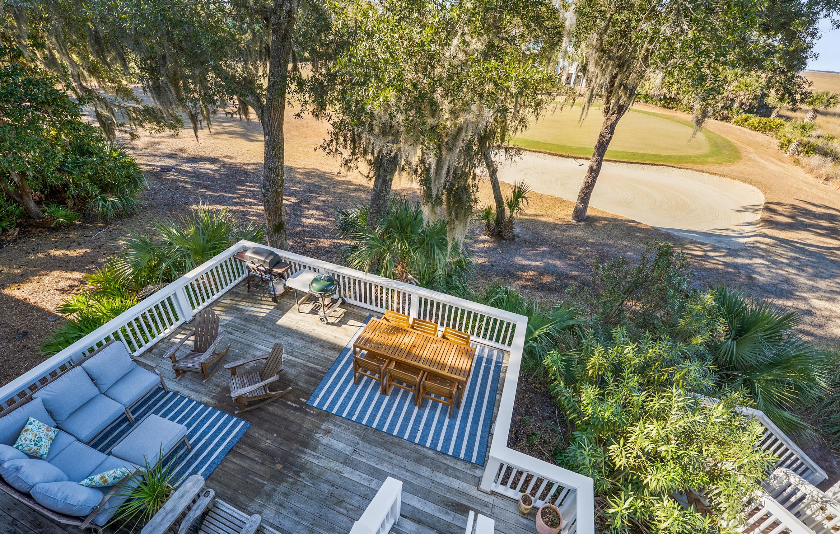 Two Tier Back Deck. Features an Outdoor Sectional, a Teak Dining Table and Both Gas and Charcoal Grills.