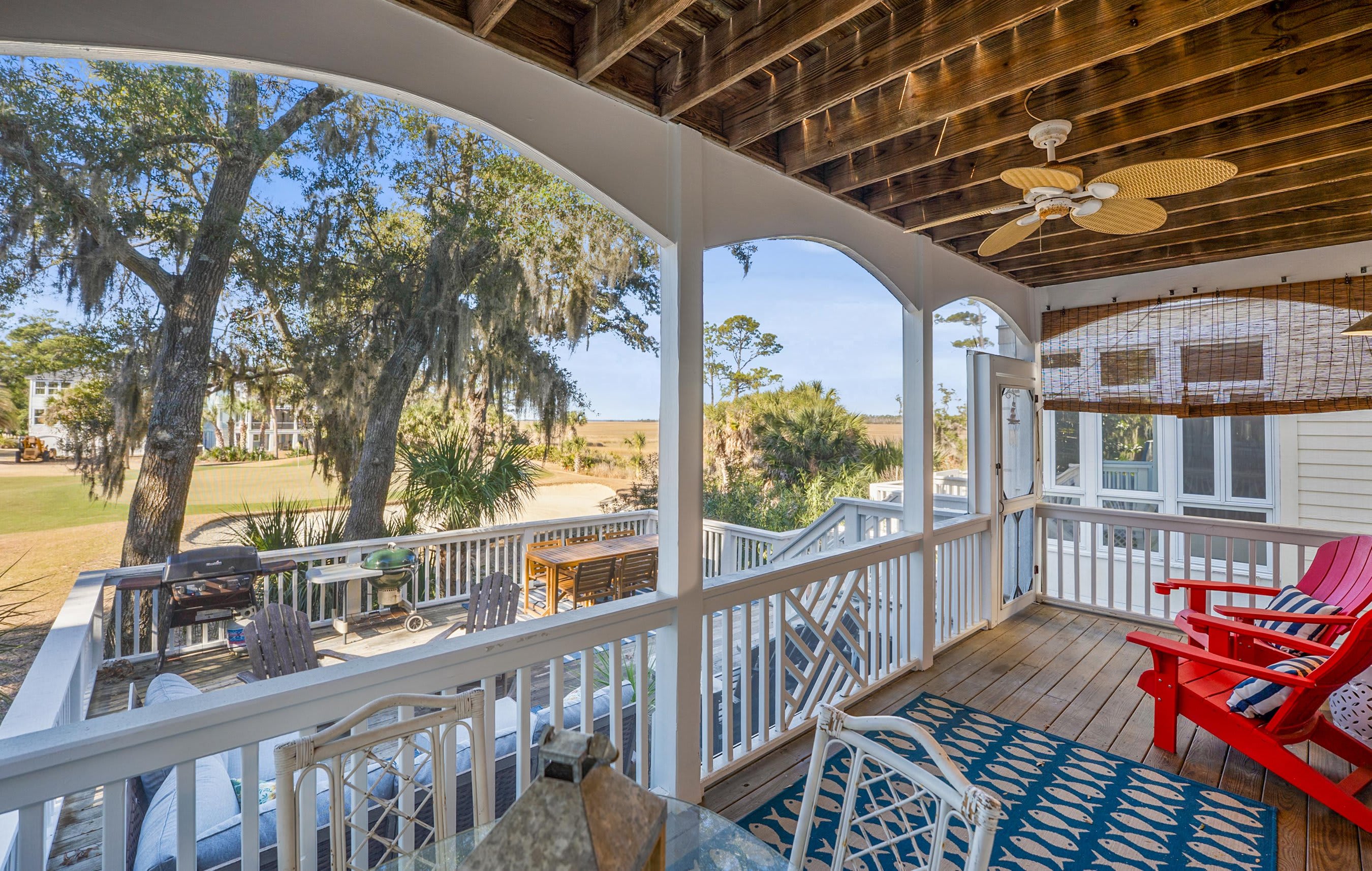 Two Tier Back Deck. Features an Outdoor Sectional, a Teak Dining Table and Both Gas and Charcoal Grills.