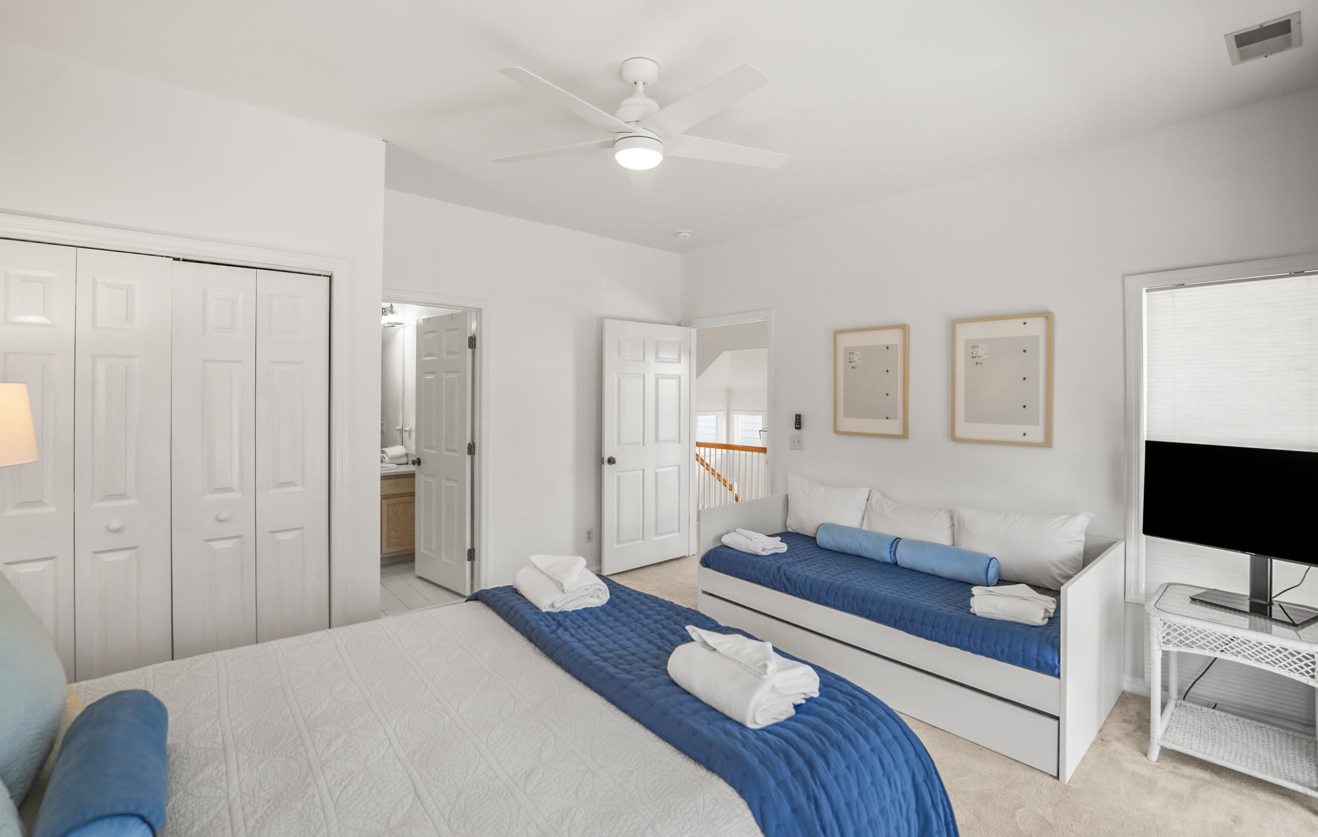 Queen Bed with a Twin Bed with Twin Trundle, Comfortably Sleeping Additional Guests. It Includes an Ensuite Bath (shower/tub combo) and Access to a Shared Deck with Seating Overlooking Bonito Road. 