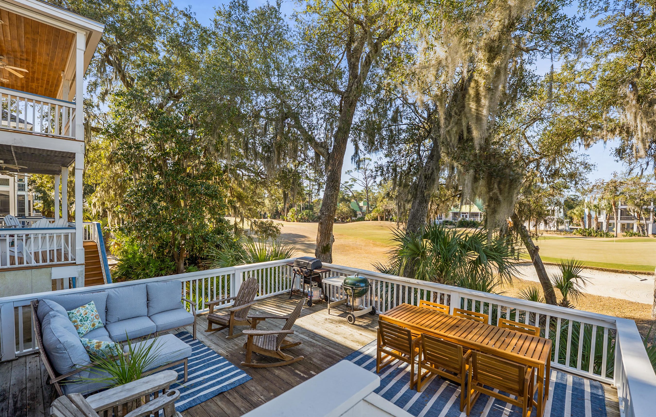 Two Tier Back Deck. Features an Outdoor Sectional, a Teak Dining Table and Both Gas and Charcoal Grills.