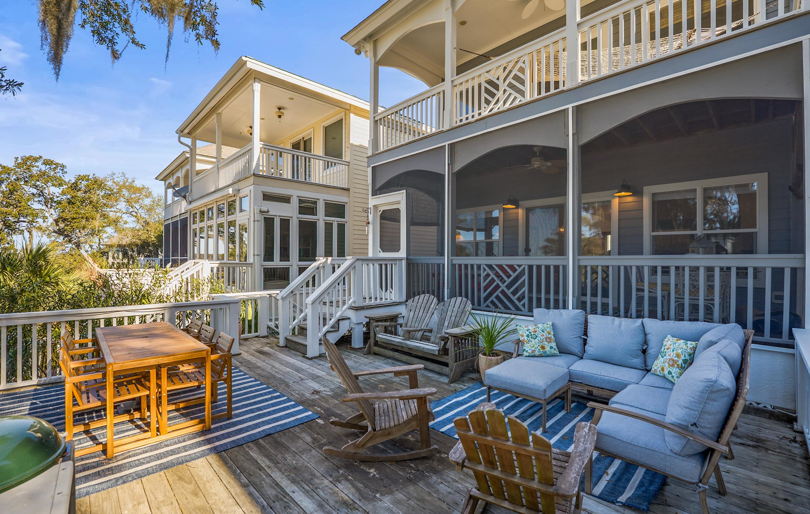Two Tier Back Deck. Features an Outdoor Sectional, a Teak Dining Table and Both Gas and Charcoal Grills.