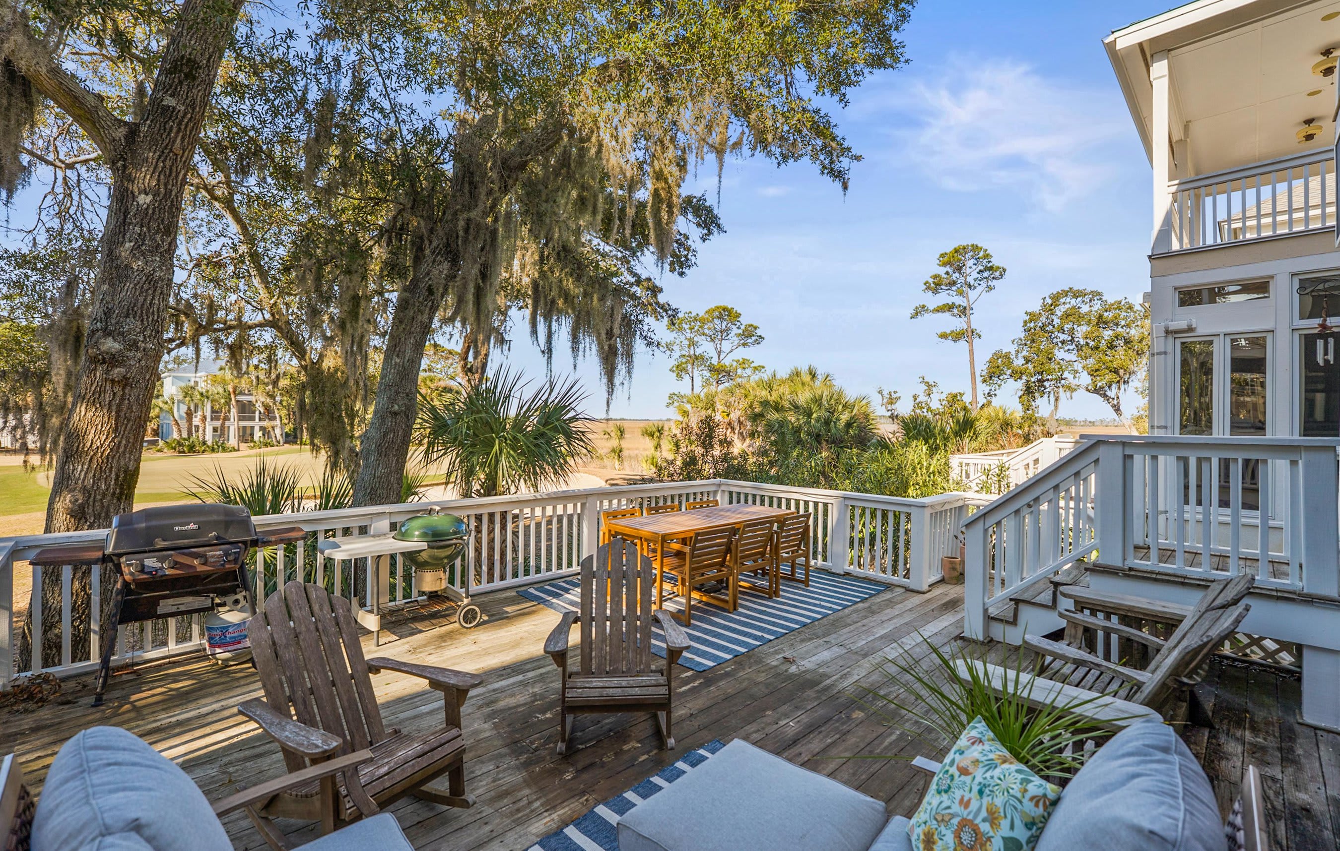 Two Tier Back Deck. Features an Outdoor Sectional, a Teak Dining Table and Both Gas and Charcoal Grills.