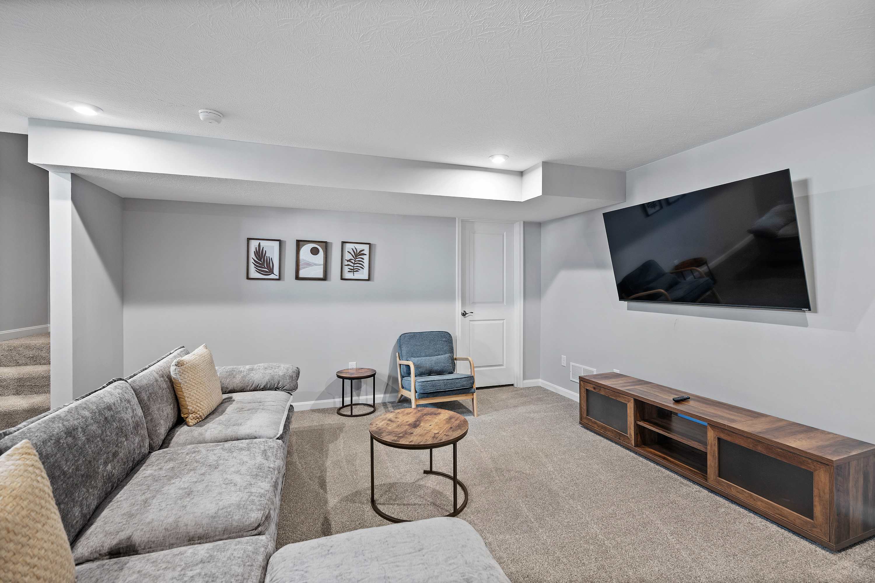 The lower-level den is ideal for epic movie nights at home​