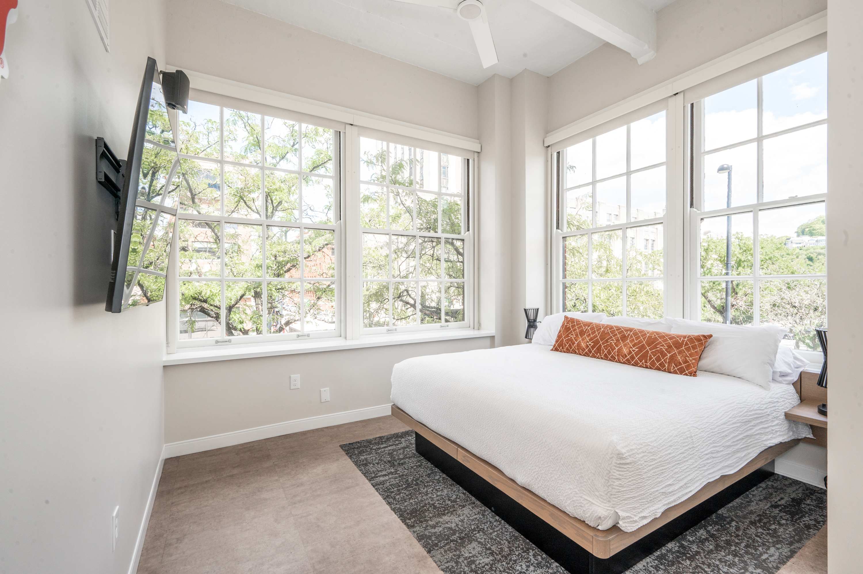 Recharge in Suite 203’s first queen bedroom, offering a smart TV & sweeping views​