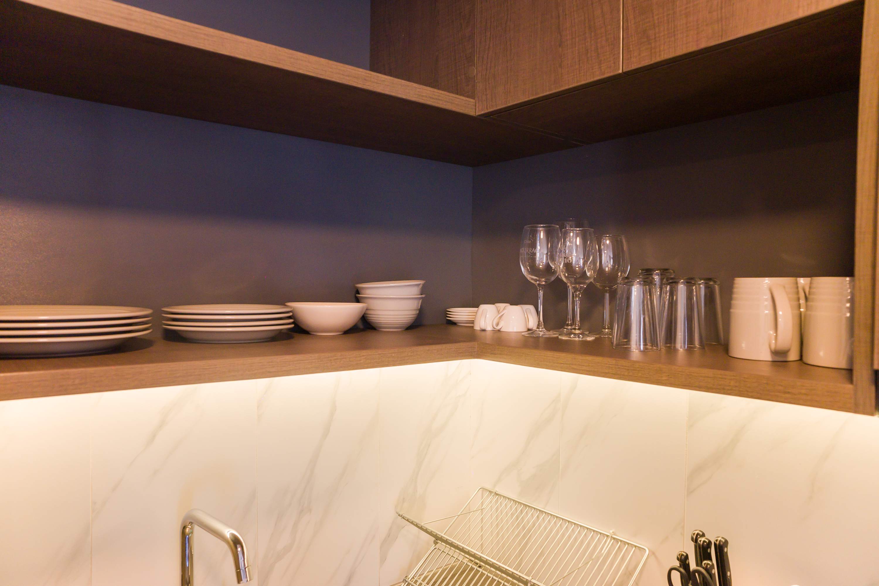 Well-equipped kitchen with stylish shelving and modern amenities, perfect for preparing meals during your stay.