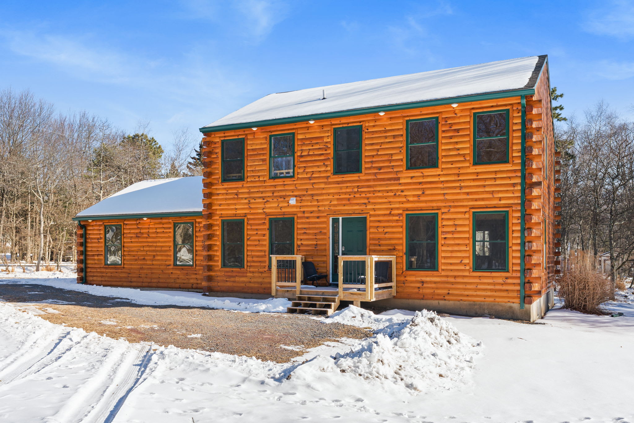 Welcome to the cabin — a charming two-story log home nestled in the Poconos woods