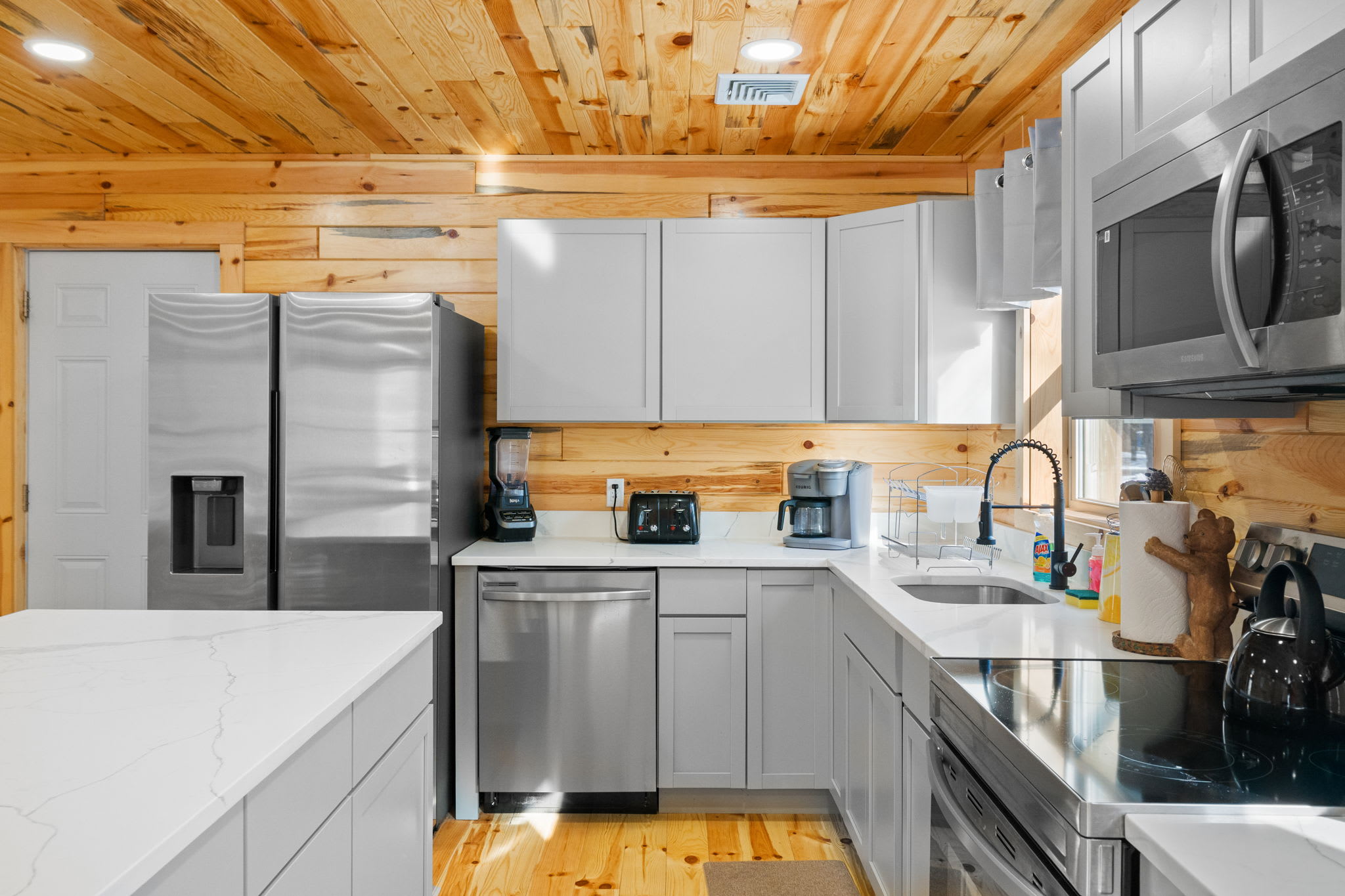 The kitchen sink area with dishwasher, coffee maker, and all the essentials