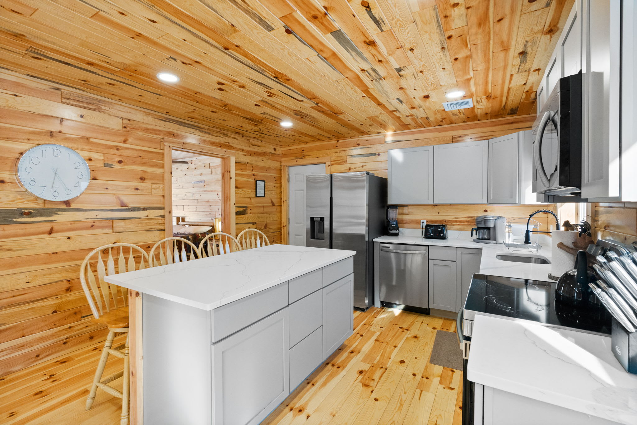 Bright and inviting kitchen with island seating and views into the cabin living spaces