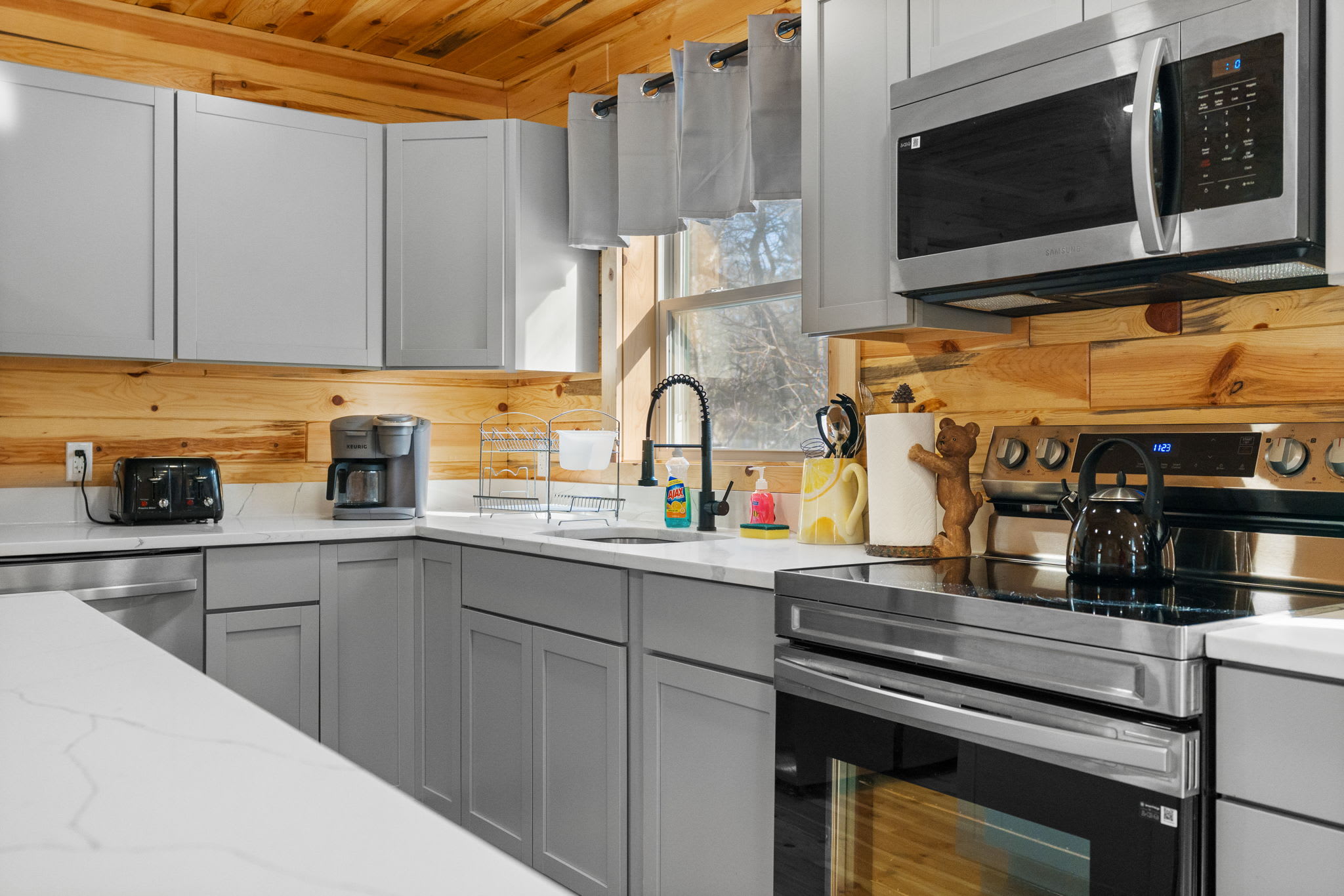 Stove, microwave, toaster, and coffee maker lined up and ready for your meals