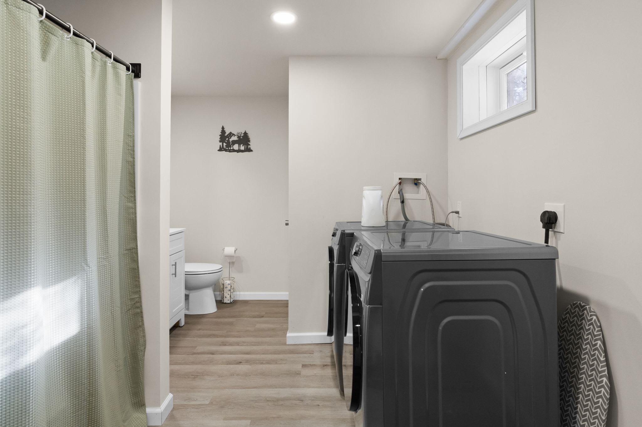 Bathroom with shower and an in-unit washer and dryer for easy laundry during your stay