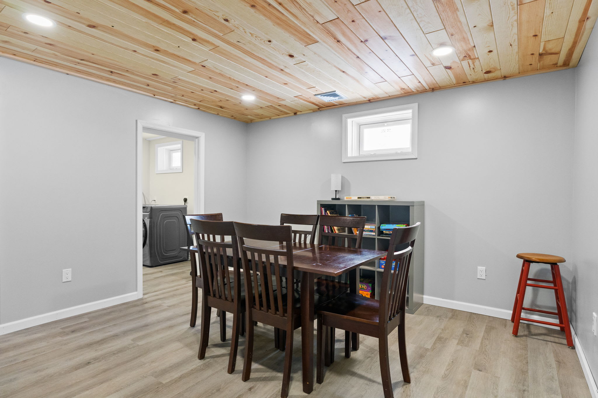 The lower level offers extra dining space with storage shelves and easy laundry access