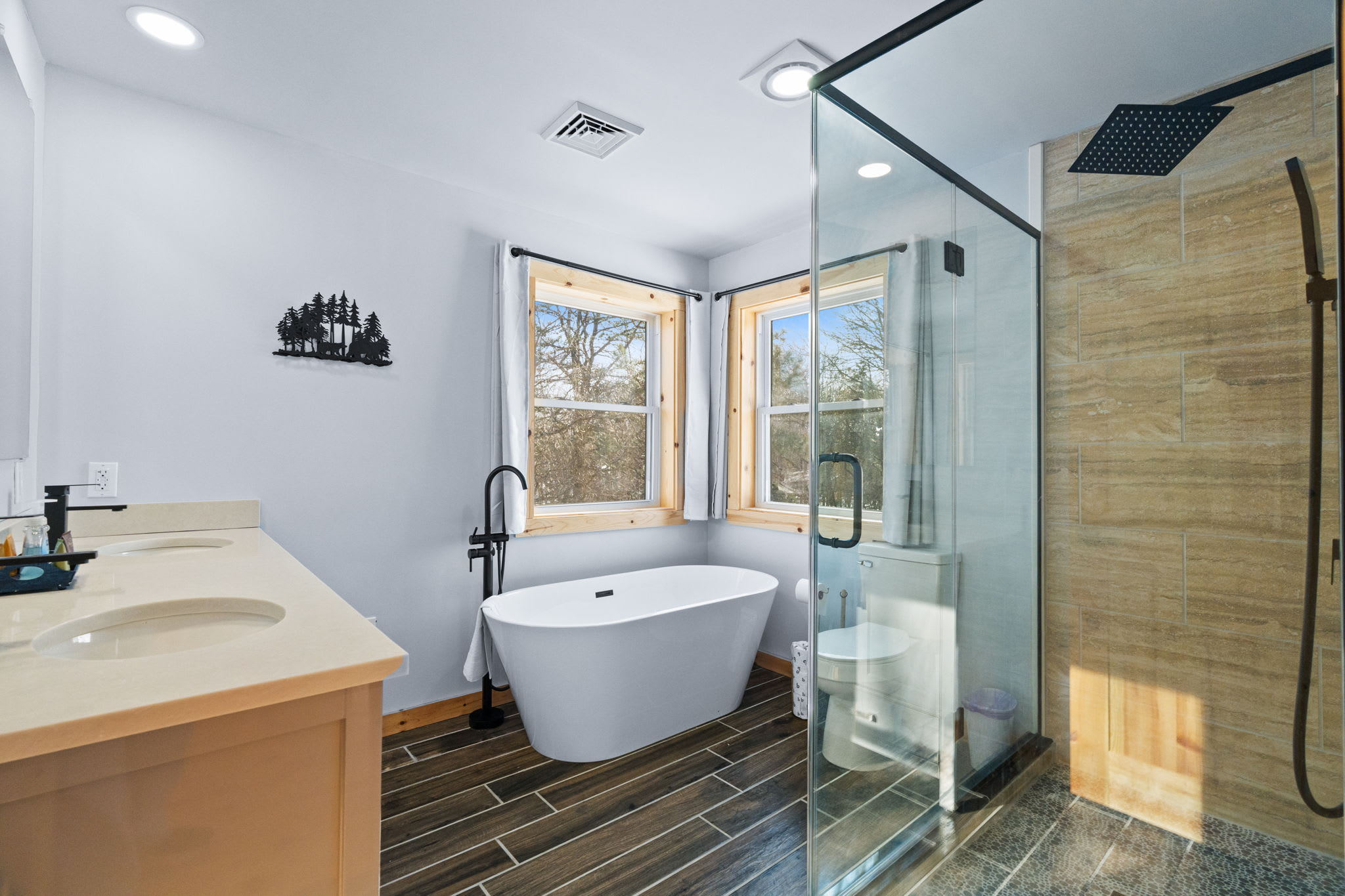 Soak away the day in the freestanding tub with views of the woods