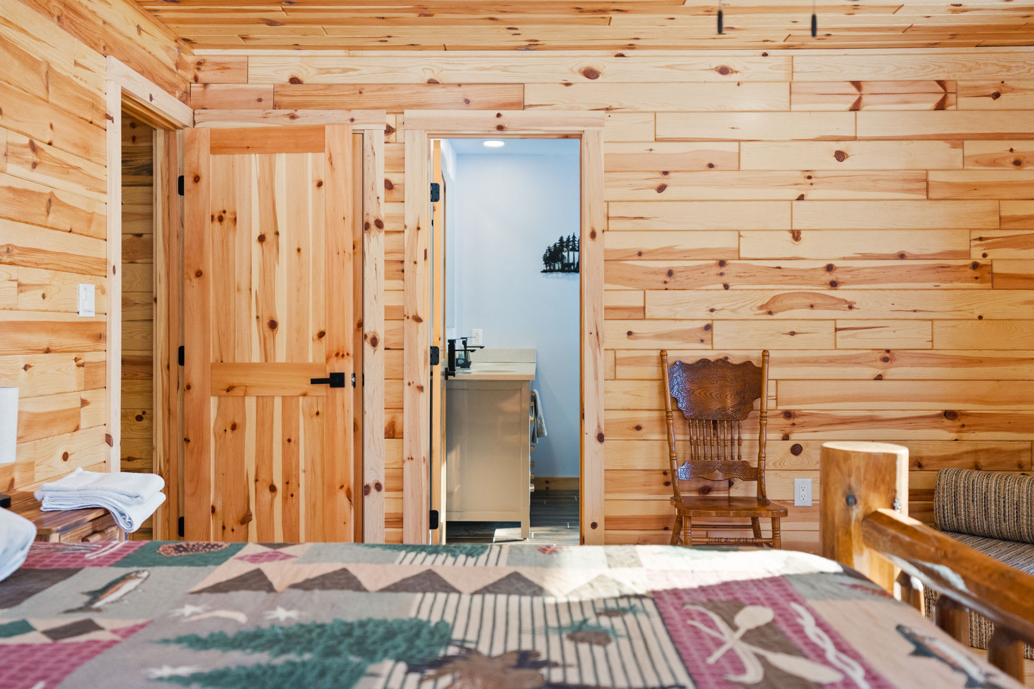 Step through the log-framed hallway connecting the cabin's cozy rooms