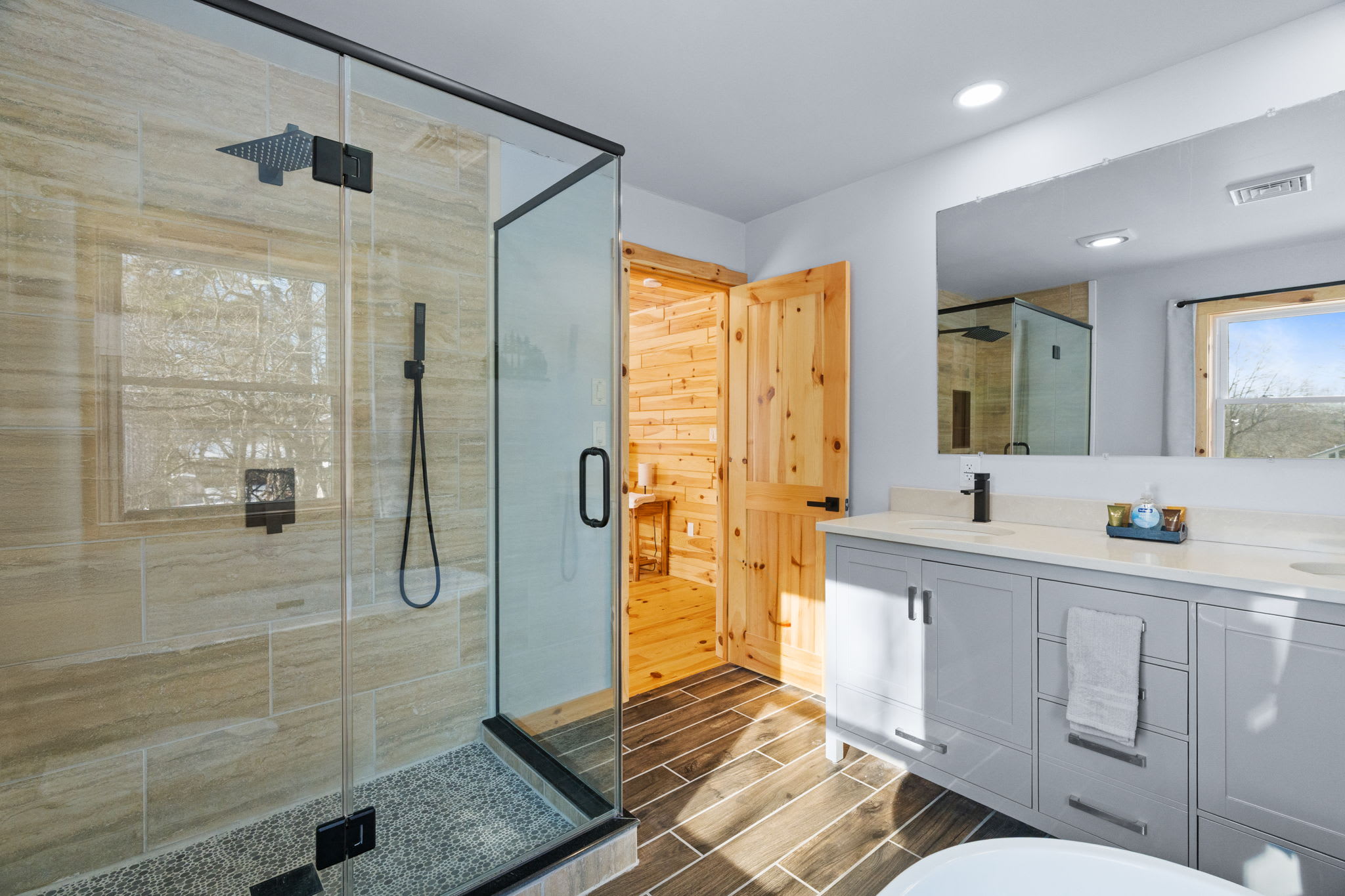 A sleek walk-in shower and freestanding tub complete this relaxing cabin bathroom