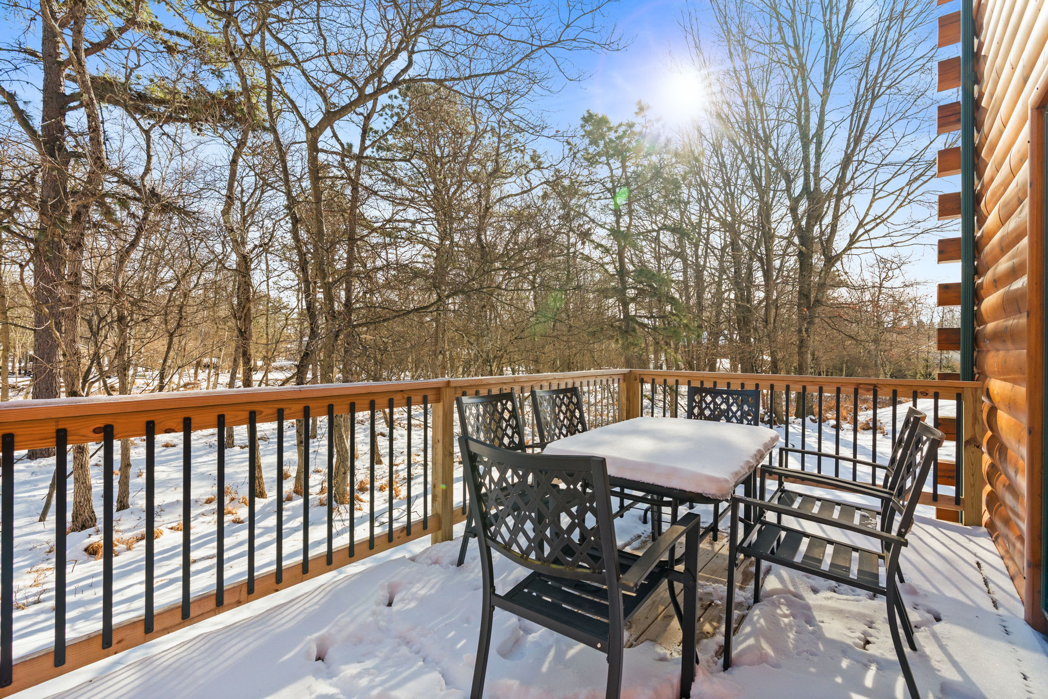 Dine al fresco on the spacious deck surrounded by peaceful wooded views